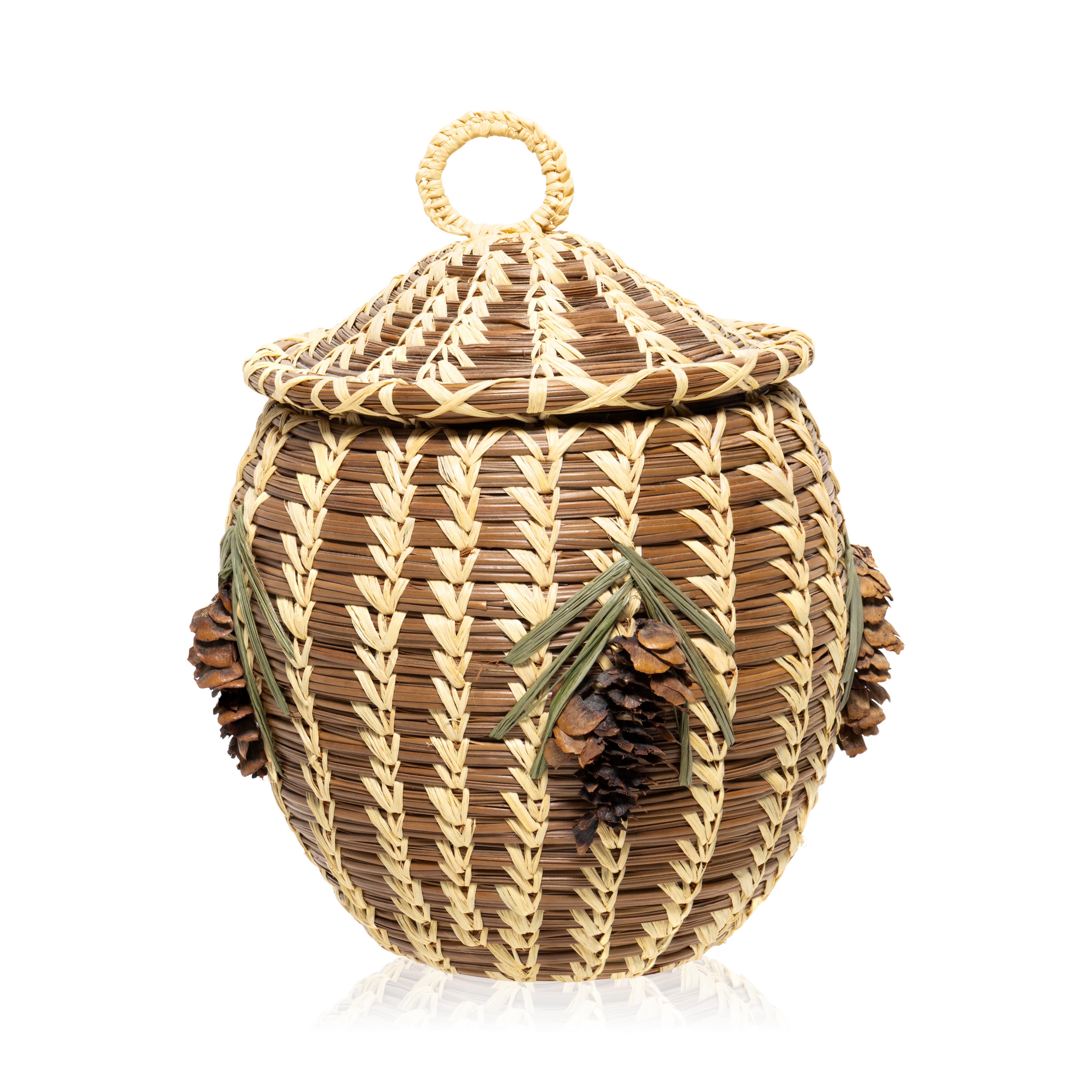 Coushatta lidded pine needle basket with pine cone and needle décor two sides and top. This woven by L.C. John, the last of the great Coushatta basket makers. This basket is made from longleaf pine needles native to the state stitched with raffia