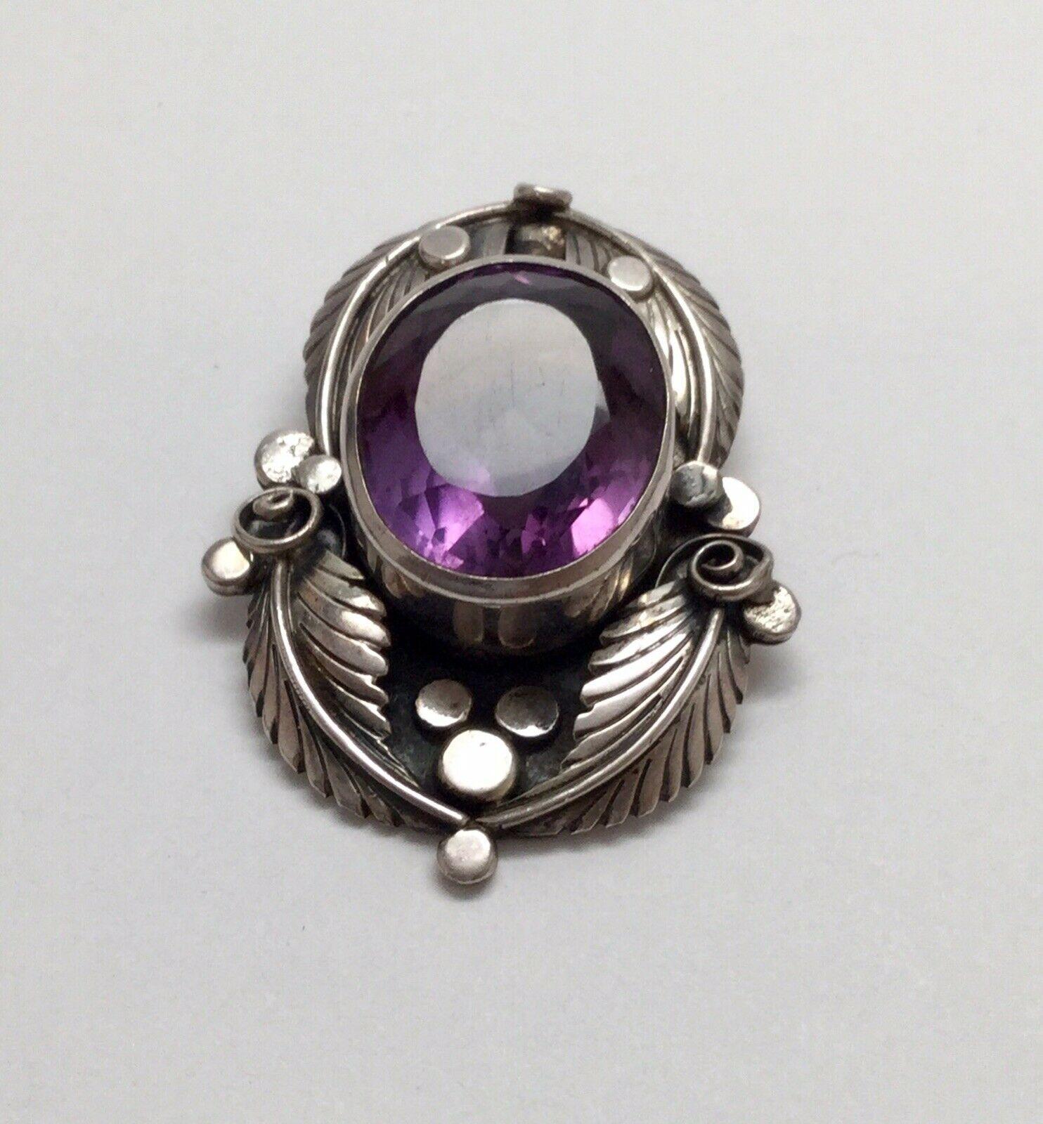 Native American E. Billy Sterling silver amethyst double bale pendant.

Marked: E. Billy, Sterling

Measures: 2