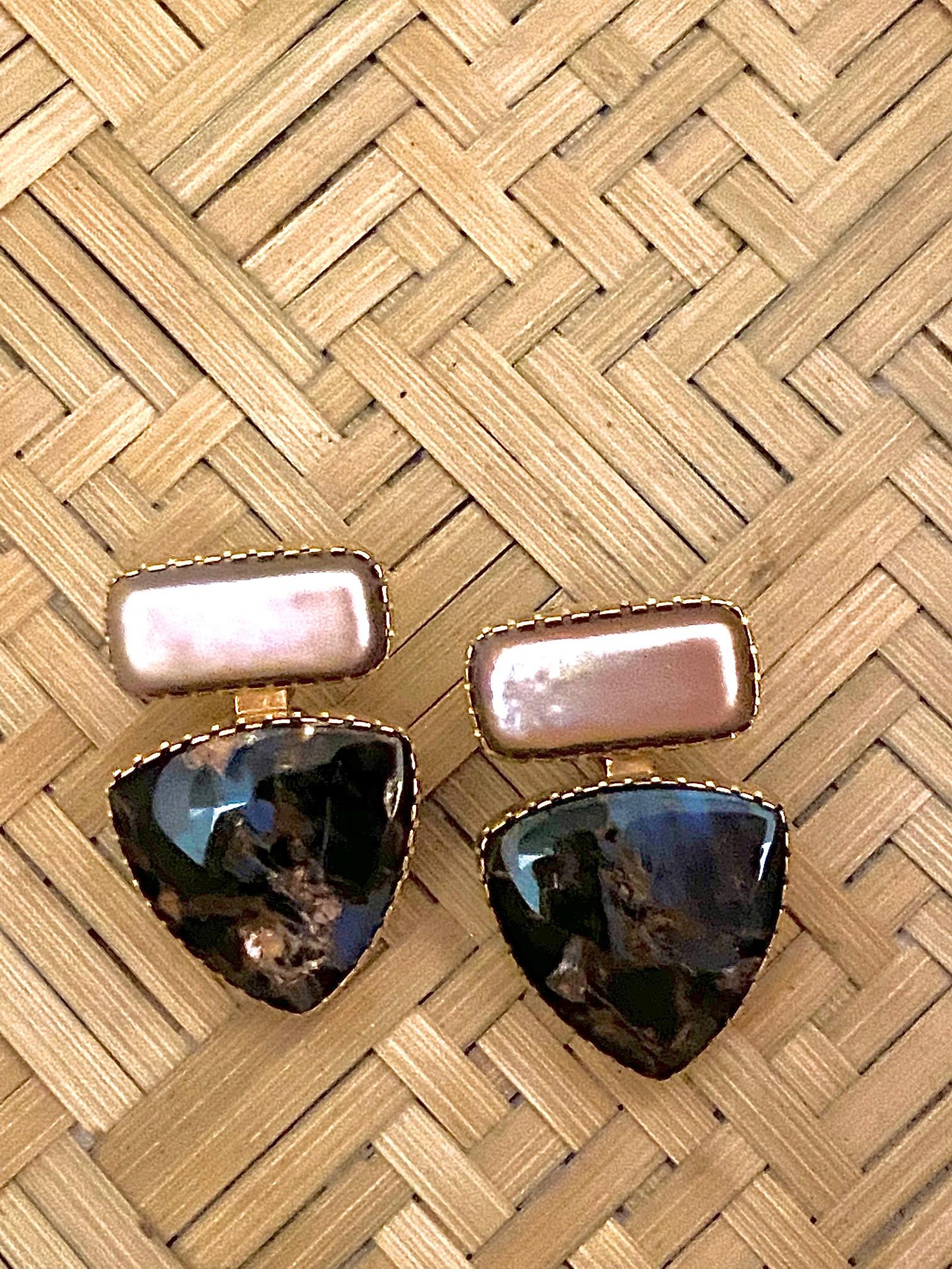 A pair of freshwater pearl, pietersite, and 18 karat gold earrings, by Native American artist jewelers Gail Bird and Yazzie Johnson. Post with clip closure. Maker's mark for Gail Bird and Yazzie Johnson. Stamped 18k. 
Friends since childhood, Gail