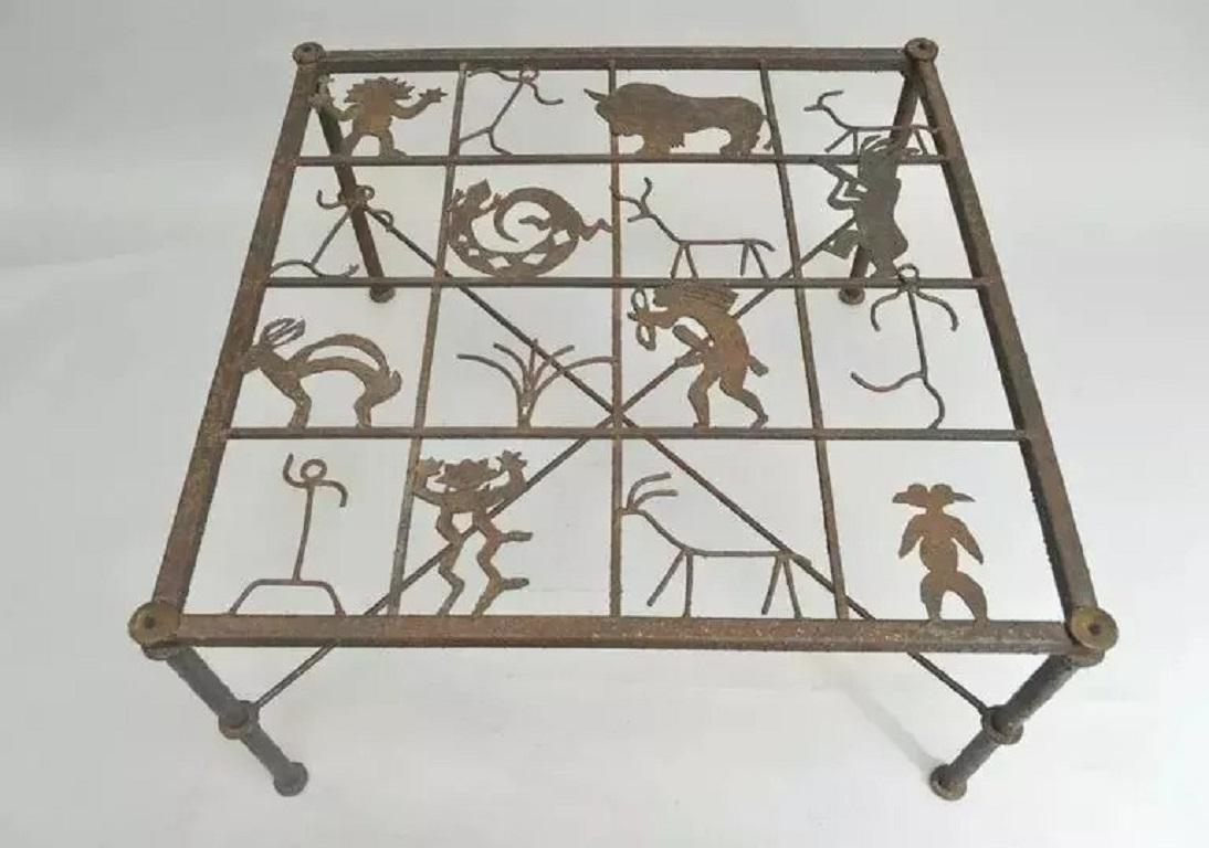 Metal and Glass Square Brutalist Coffee Table with Native American Glyph Figures. Item features a patinated rustic metal frame with X-form stretcher base and 16 figures on the top which is covered by a substantial 38