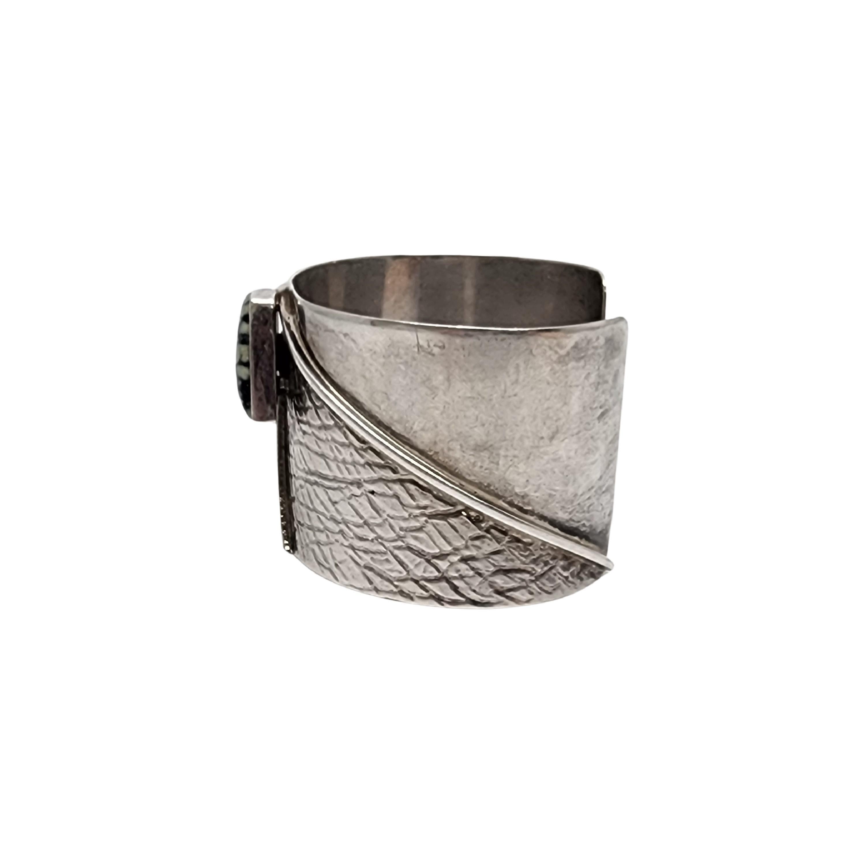 Sterling silver turquoise wide cuff bracelet by Native American artisans Henry Calladito and Paul Yellowhorse.

This large and substantial piece features a beautifully veined turquoise stone bezel set on a wide cuff.

Weighs approx 51.4g,
