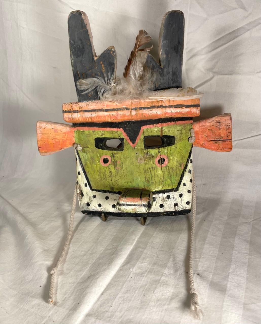 Native American Hopi Pueblo Antelope Kachina Mask.

Vintage Hopi Pueblo Antelope Kachina mask made from cottonwood. It is painted with pigments in soft pastel shades, with added feathers and cotton strings. The rare mask was created about in the