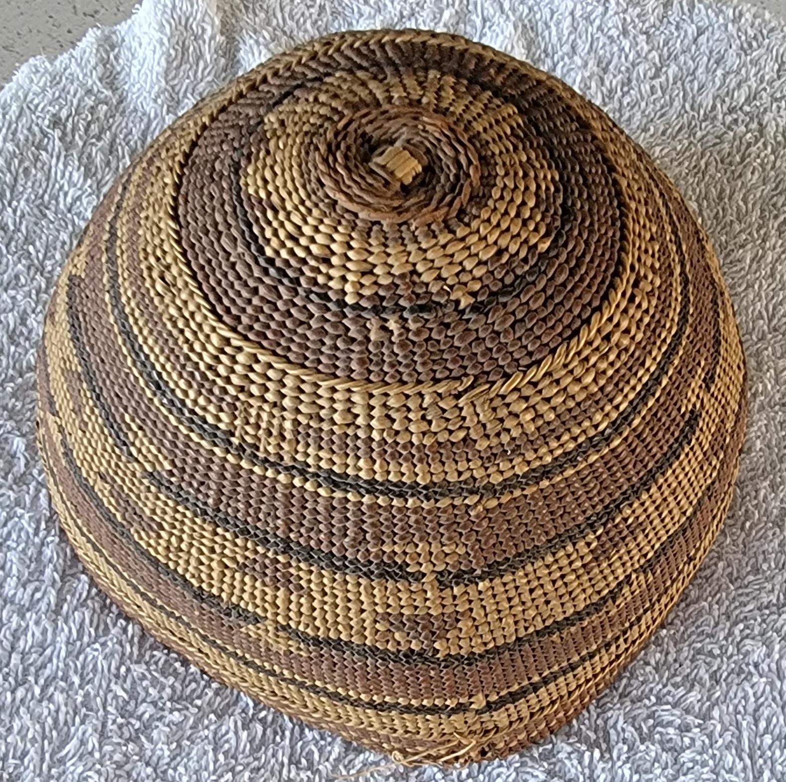 Native American Hupa hat basket. Late 1800's to early 1900's. Fine example of woven headwear often made and worn by women of the Hupa, Karuk, and Yurok tribes of Northern California. Made of grass fibers, brachen fern, and willow cane. 

