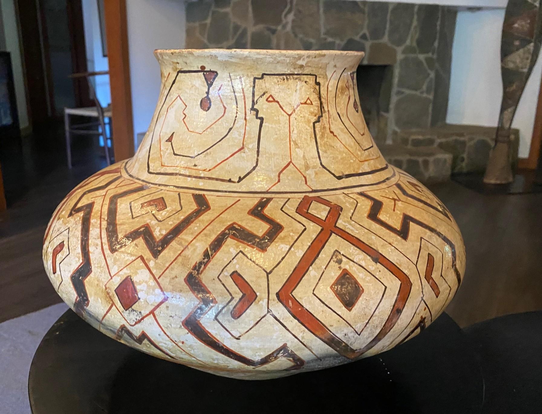A wonderful geometric patterned and designed hand painted and glazed Native American large earthenware jar/vase/pot made by the Shipibo-Conibo people, an indigenous people along the Ucayali River in the Amazon rainforest in Peru.  They are known for