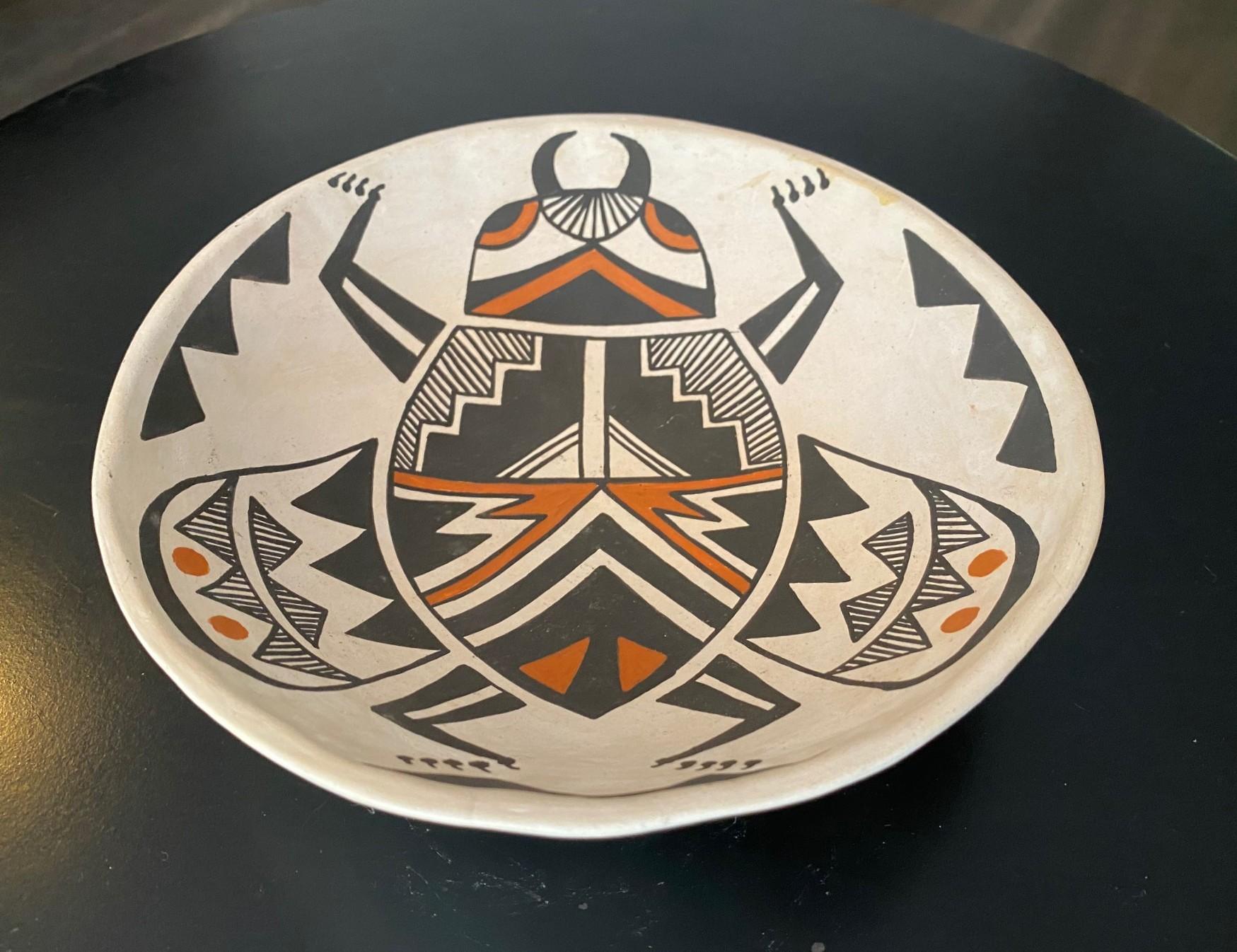 A beautiful if not a little oddly strange Indigenous Native American Southwest Acoma Pueblo of New Mexico bowl featuring a wonderful hand painted beetle/bug/insect motif.  

The bowl is signed by the artist on the underside and noted 