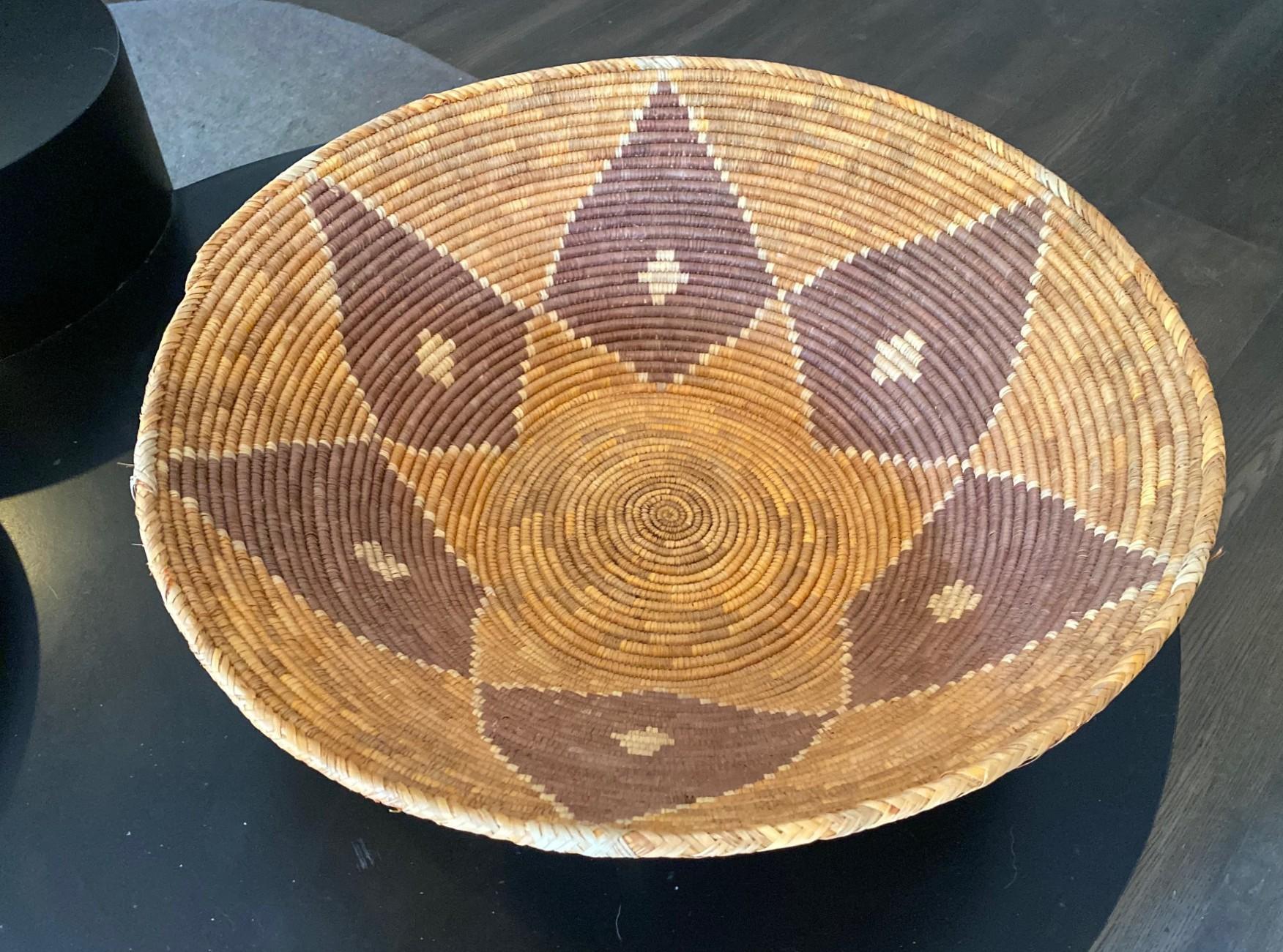A wonderful designed, quite large rounded coil basket by the Indigenous Southwestern Native American Navajo Tribe. Originally presented and used in a traditional tribal wedding ceremony. The piece is nicely weaved and beautifully decorated with a
