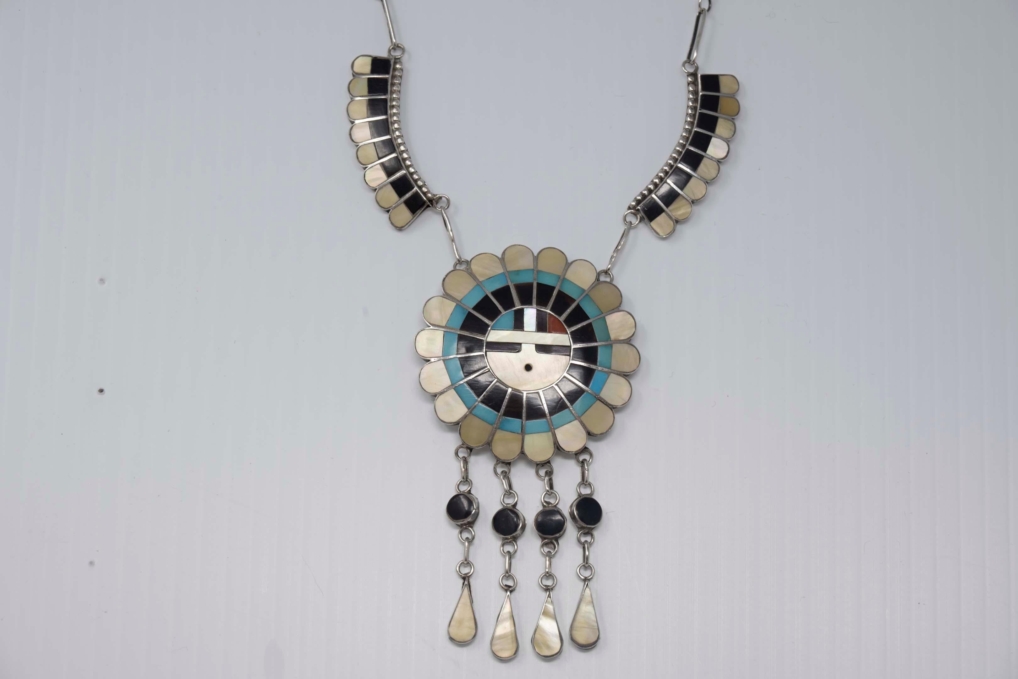 Native American Zuni artist by J.D. Massie sterling silver inlaid sun god necklace. Signed on the back, measures 19 inches long. Very good condition.
