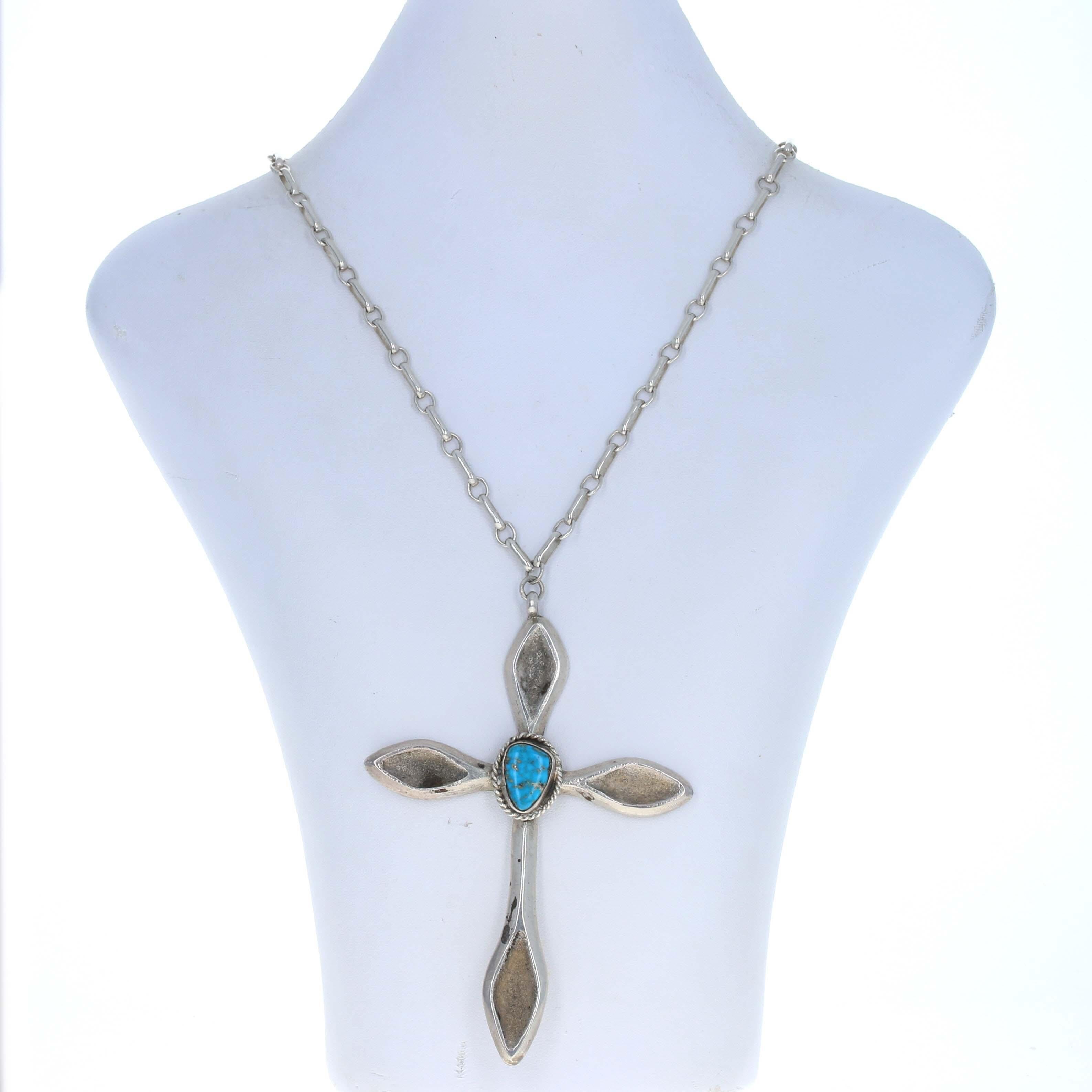 Affirm the importance of your faith with this handsome cross necklace. This is a Native American piece that has been crafted of sterling silver. The center of the sand-cast cross features a genuine turquoise that has been smoothly polished to show