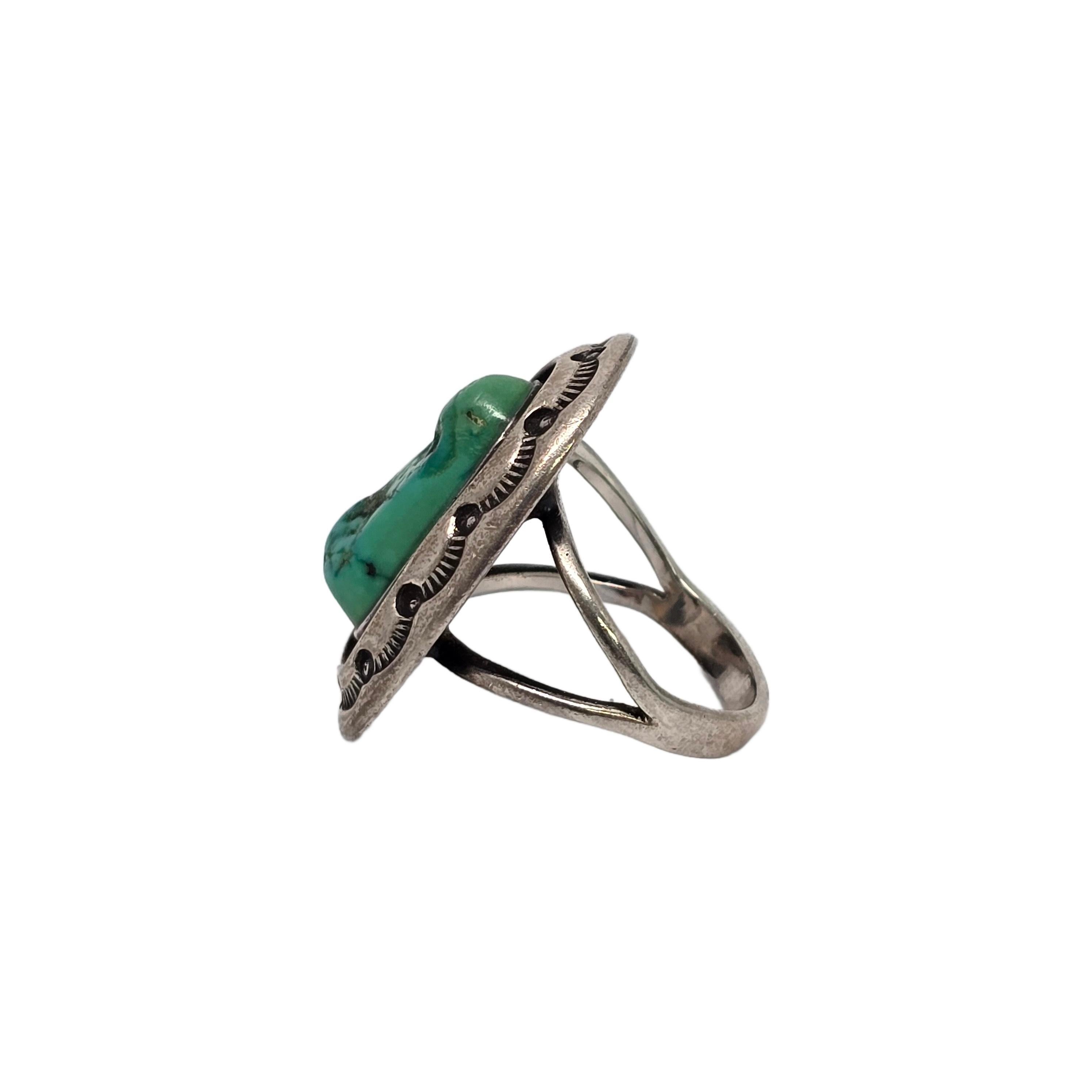 Sterling silver and green turquoise shadowbox ring by Native American Navajo artisan LeRoy Begay.

Size 7 3/4

A beautiful example of Begay's signature shadowbox style, this ring features a green turquoise ring bezel set within a shadowbox design