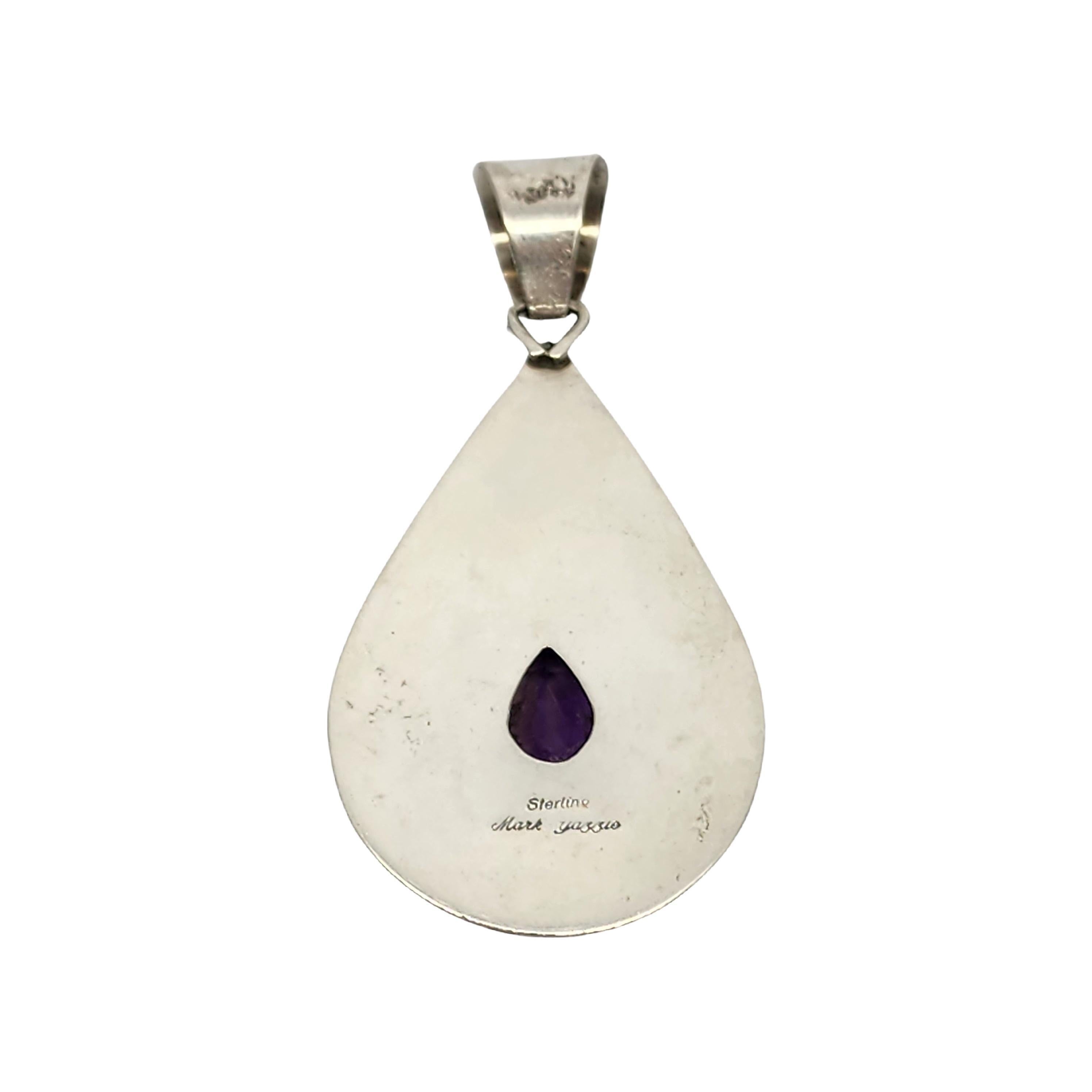Sterling silver amethyst teardrop pendant by Native American Navajo artisan, Mark Yazzie.

Large teardrop pendant with Native American symbols: feathers, bear claws and mountains. Faceted tear drop purple amethyst is prong set it the pendant's