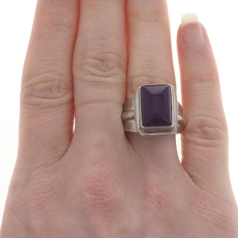 Size: 7 1/4
Note: Manually adjustable up multiple sizes or down ~1 size

Native American
Artisan: Mike Smith
Tribal Affiliation: Navajo

Metal Content: Sterling Silver

Stone Information

Natural Sugilite
Cut: Rectangular Cabochon
Color: