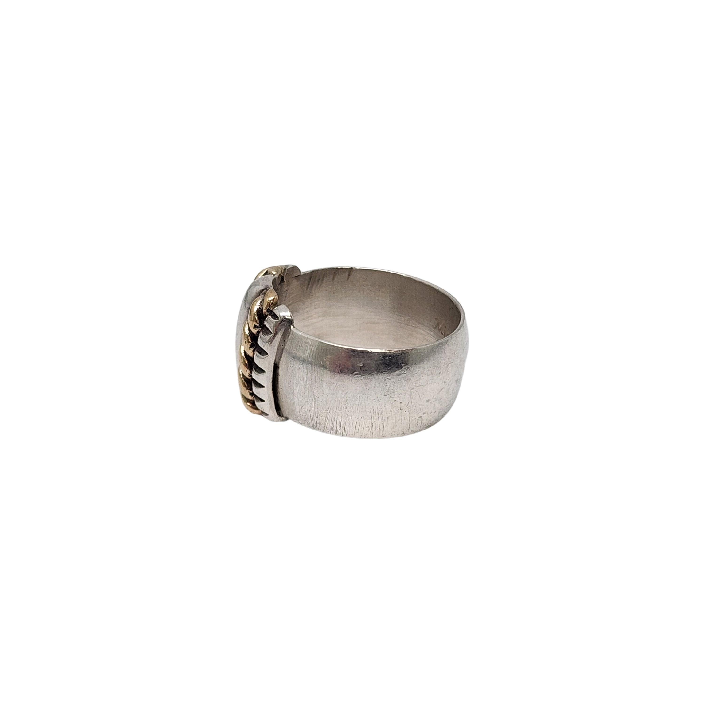 Sterling silver and 14k yellow gold accent band ring by Native American artisan Mike Smith.

Size 6 1/2

This wide sterling silver band features a yellow gold rope accent.

Weighs approx 8.5g, 5.5dwt

Measures approx 1/2