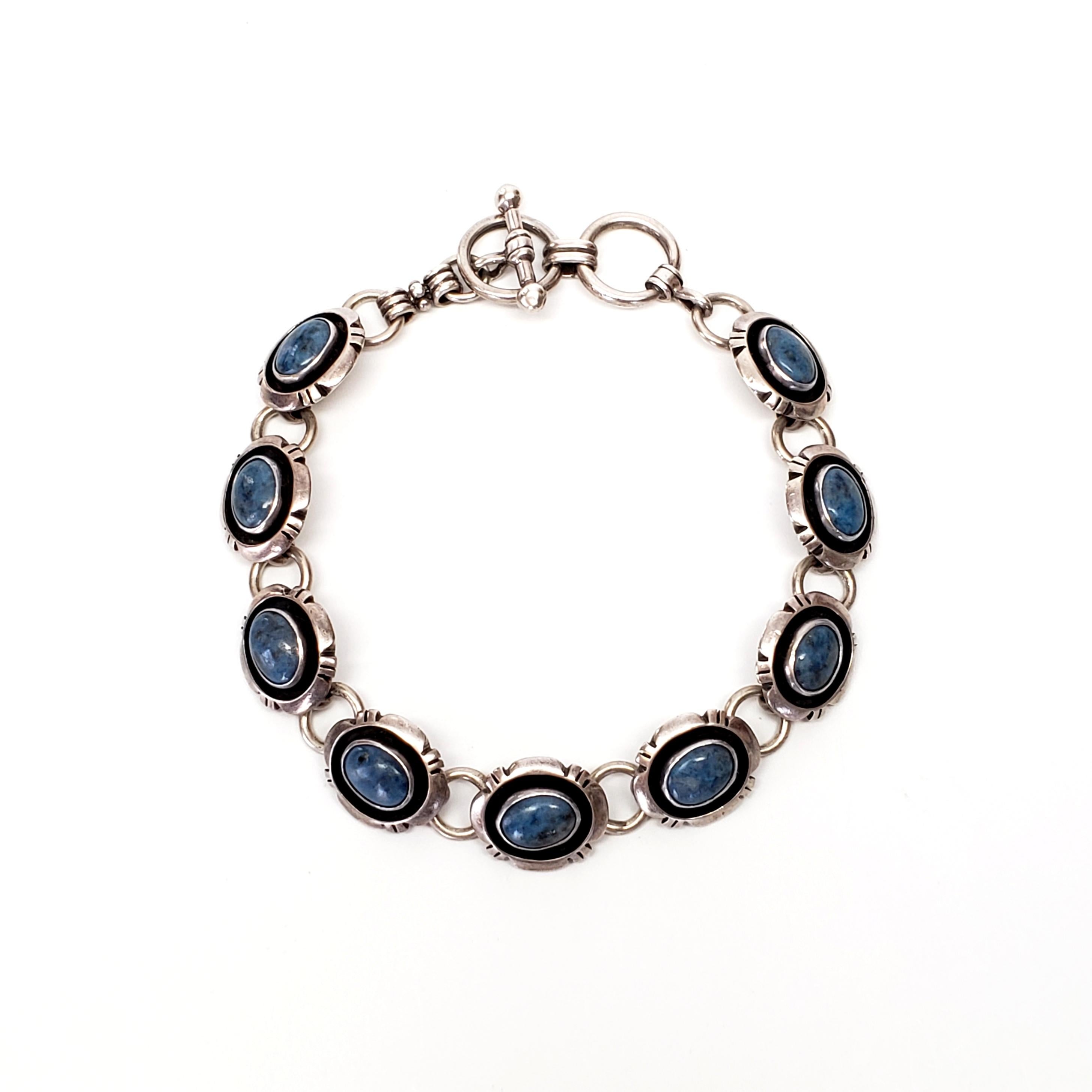 Sterling silver and lapis lazuli by Waipai silversmith Murray Jackson.

Made by Waipai artisan Murray Jackson, this bracelet features oval bezel set lapis lazuli stone oval links.

Measures approx 7 1/2