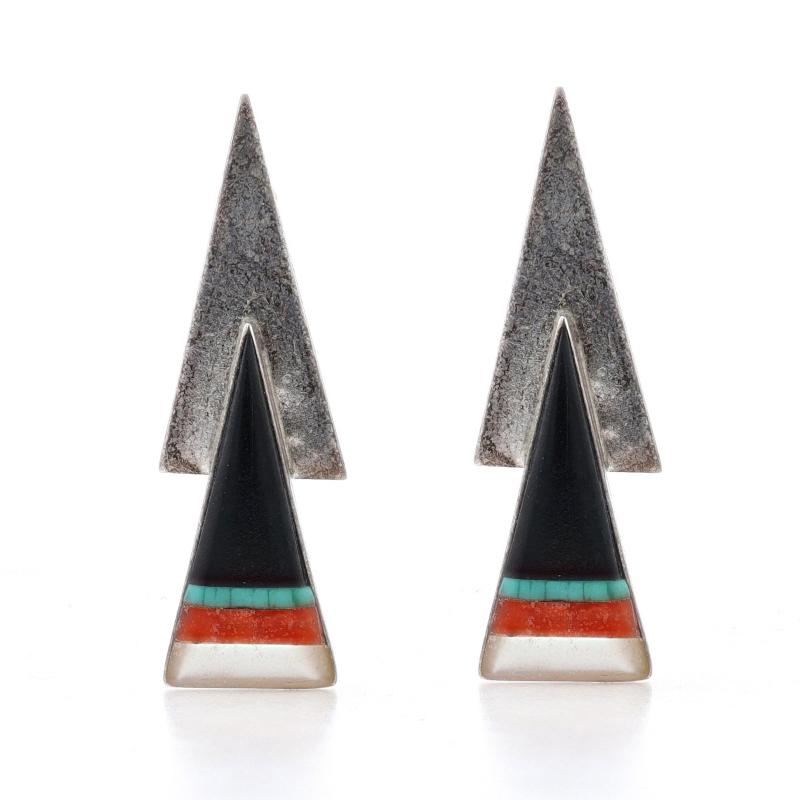Native American
Artisan: Myron Secakuku
Tribal Affiliation: Hopi

Metal Content: 925 Sterling Silver

Stone Information

Natural Jet
Color: Black

Natural Turquoise
Treatment: Routinely Enhanced
Color: Bluish Green

Natural Coral
Color: Orangey