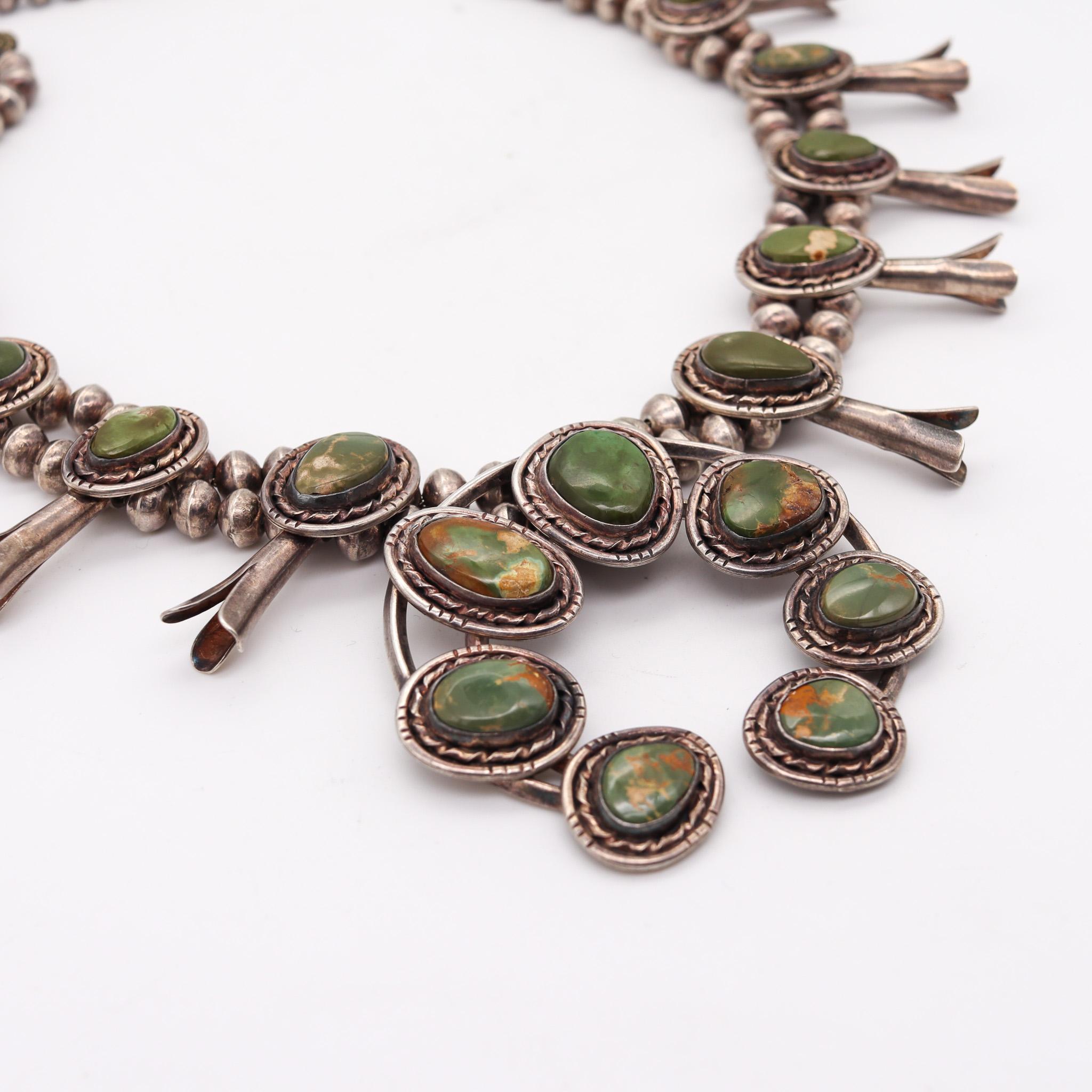 Exceptional Native American Navajo necklace.

A beautiful vintage tribal piece, created in Arizona by the Navajo native Americans back in the 1950. This squash blossom necklace was entirely crafted in solid .935/.999 sterling silver and fitted with
