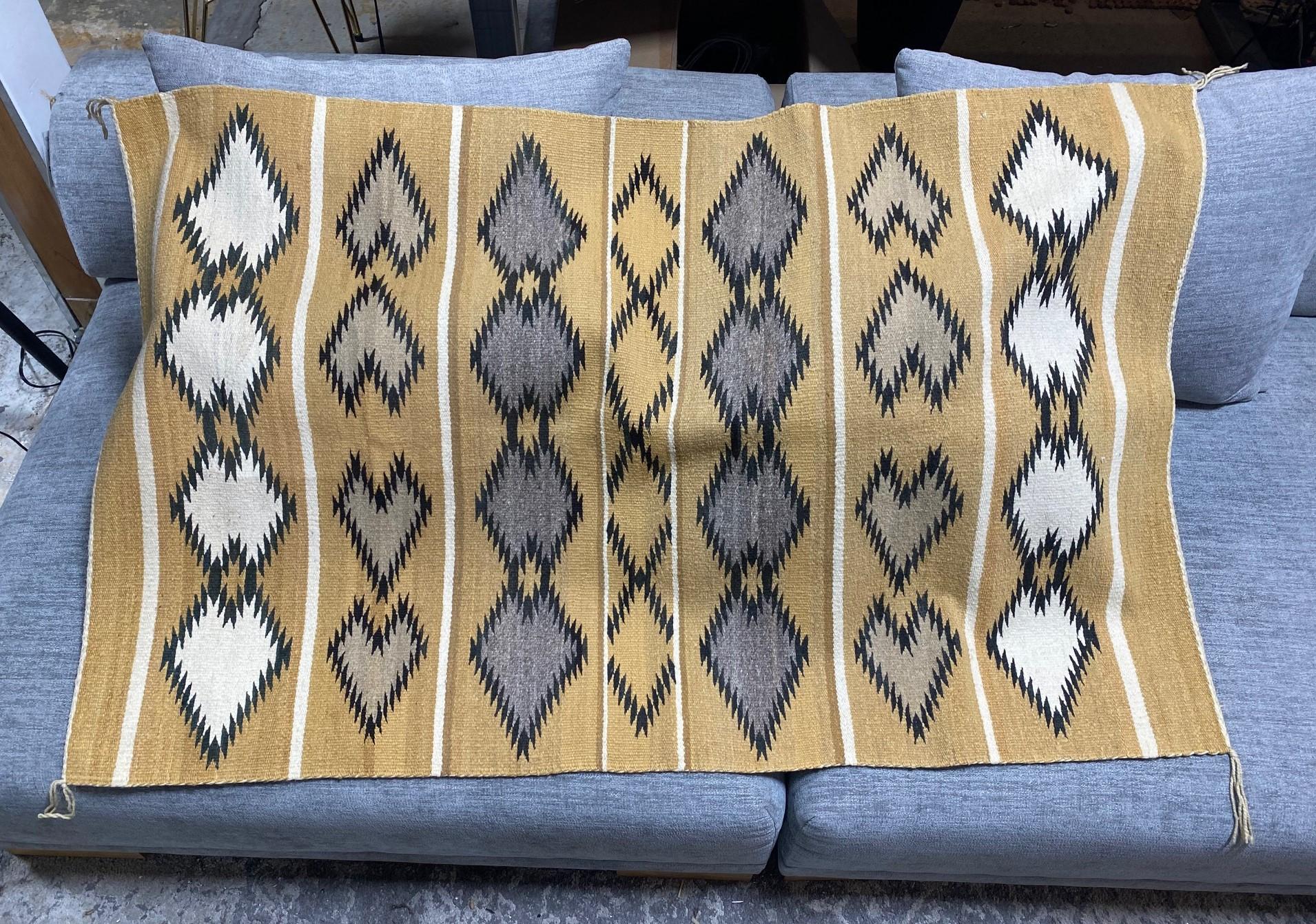 An intricately woven Native American Navajo rug featuring beautiful coloring and repeating geometric patterns for which the Navajo tribe is famed. In fantastic original vintage condition. 

From a Los Angeles collection of Native American artifacts