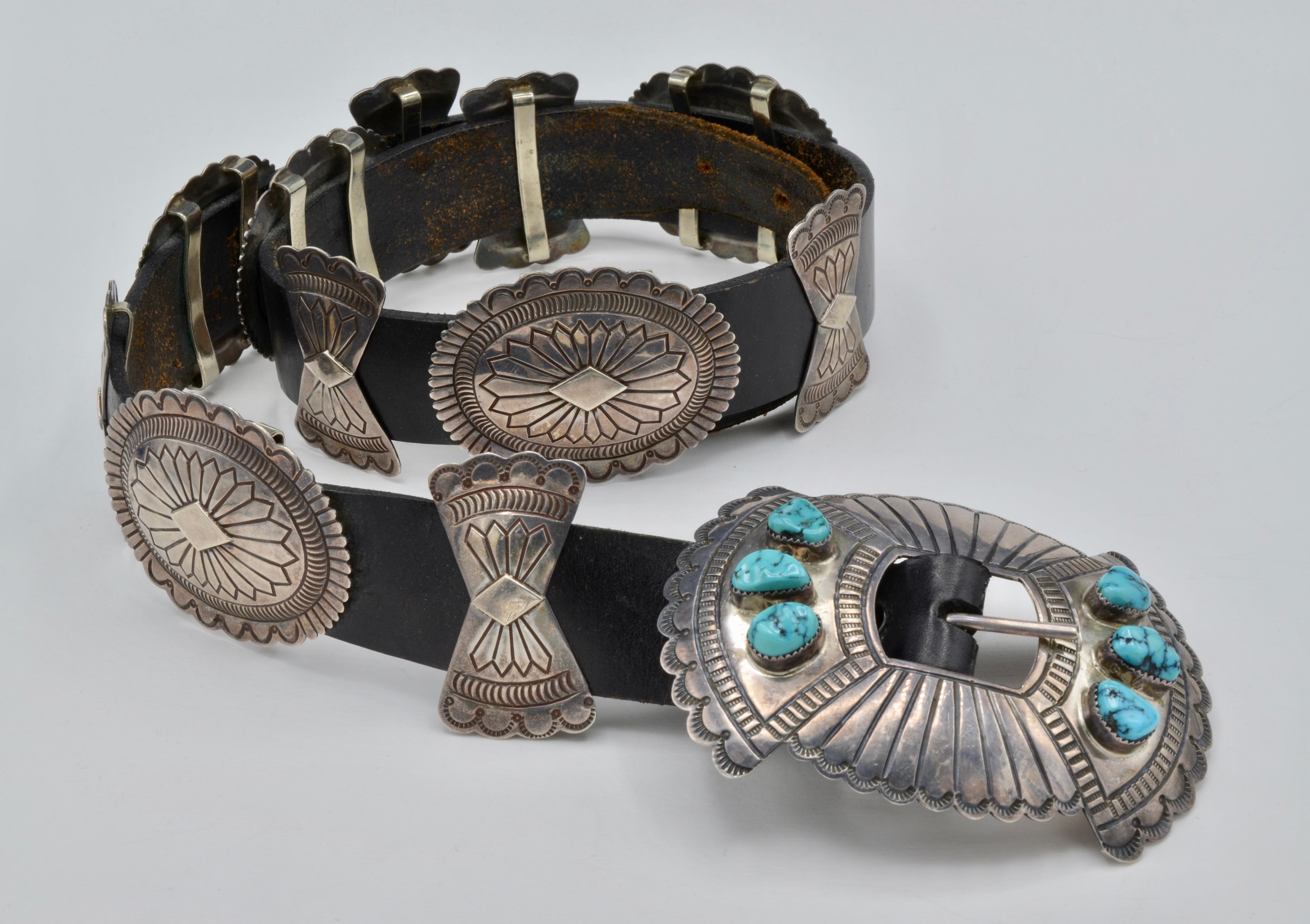 Navajo Concho Belt- This vintage leather and turquoise belt is made of silver and stamped S. James (Susie James) on the back. In fantastic condition this belt has four adjustable holes and each silver piece is hand stamped. The main buckle had six