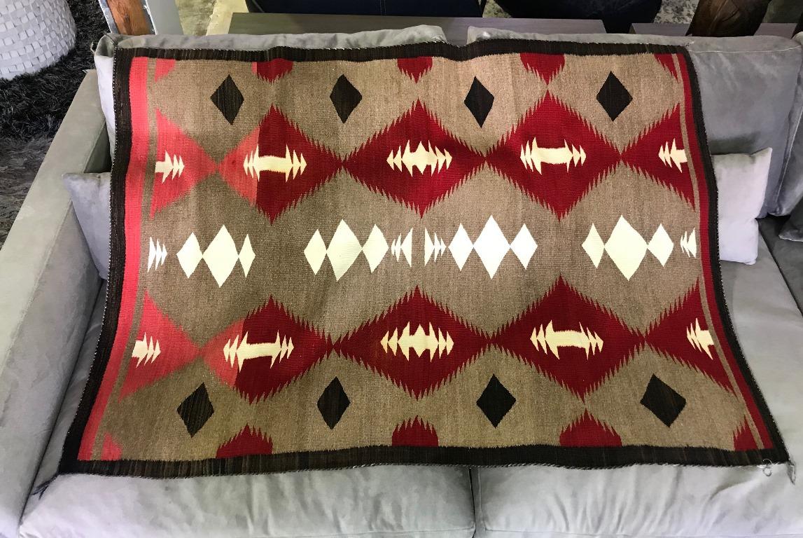 A beautiful Native American Navajo Crystal Region rug made from native lincoln wool, hand-carded, hand-spun, hand-dyed.

This lovely weaving is from the 1920s and has a unique Arts & Crafts style. The transition from pink to red coloring is