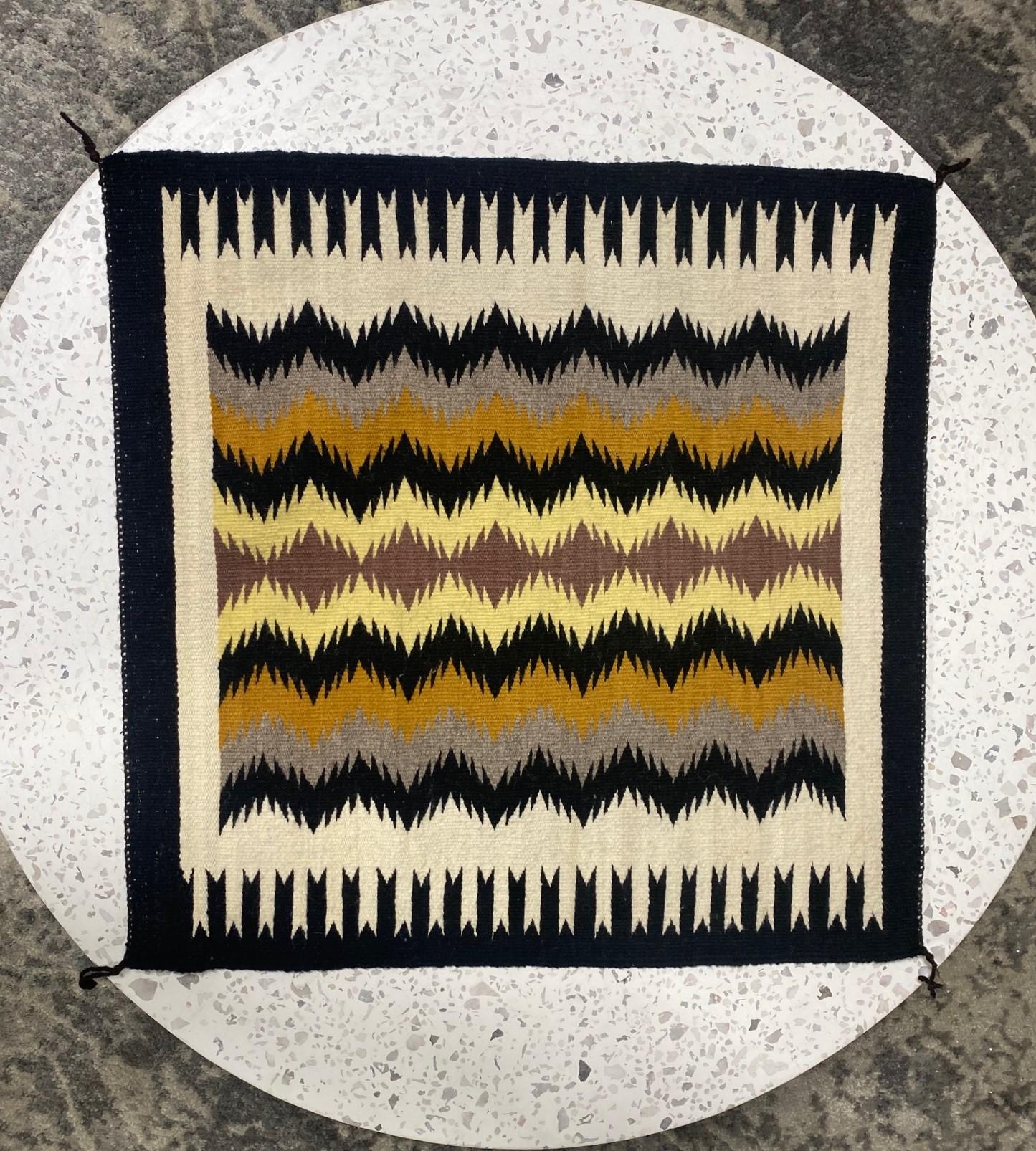 A nicely woven wool mat/rug in a geometric pattern which the Navajo tribe is famed for. In fantastic vintage condition. Originally acquired some years ago and placed in storage for good keeping. From a large collection of Native American artifacts