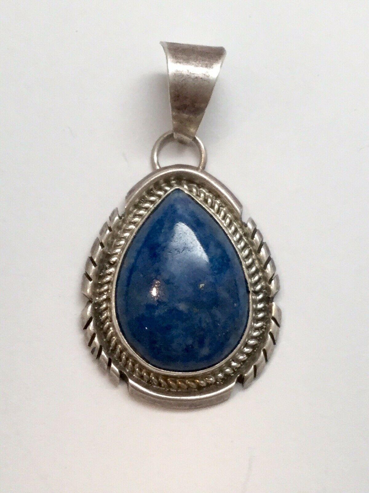 Native American Navajo IHMSS Jon McCray sterling silver lapis lazuli pendant.

Indian Handmade Sterling Silver

Marked: Jon McCray IMHSS

Measures: 2