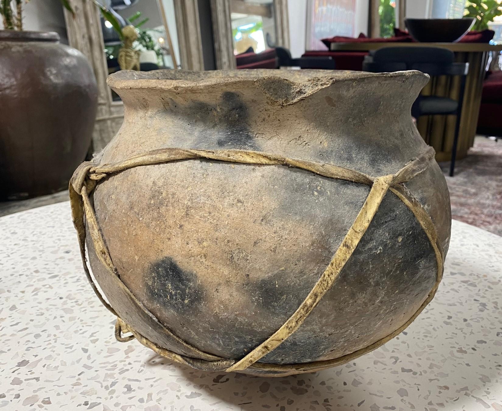 A large, quite impressive, fine example of early Native American Navajo pottery. 

We are listing it as 19th century but could be older. 

Comes with the weathered leather strapping as found. 

From a collection of Native American art and