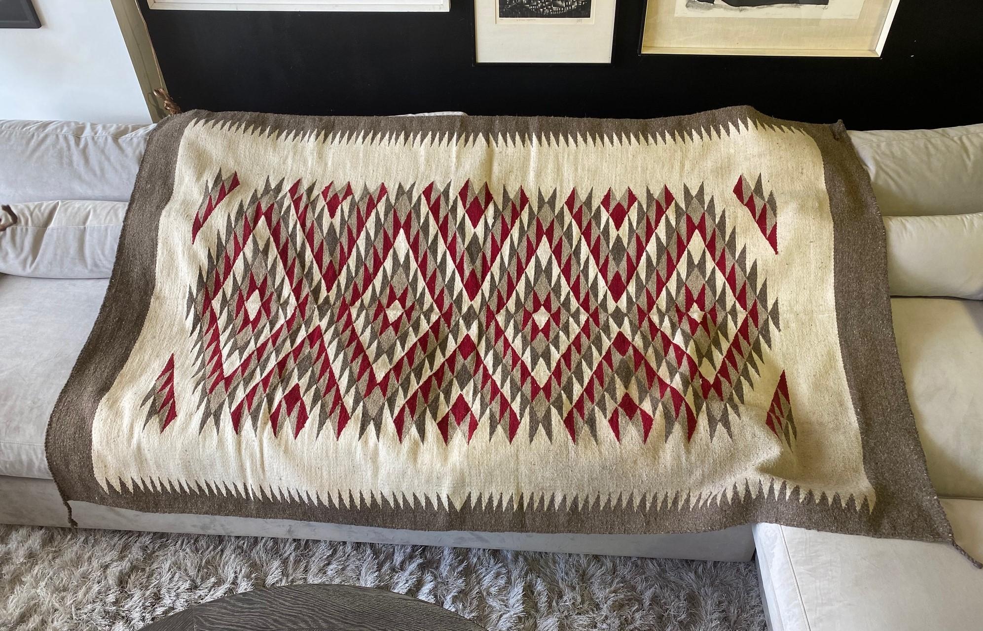 A wonderfully designed geometric patterned (of which the Navajo Tribe is famed for) blanket/rug with rich, bright colors and mesmerizing layout. Good large size. From a collection of Native American objects - pottery, blankets, rugs, etc.

Would