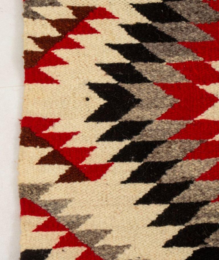 Native American Navajo rug in tones of red, black and red. 

Dealer: S138XX