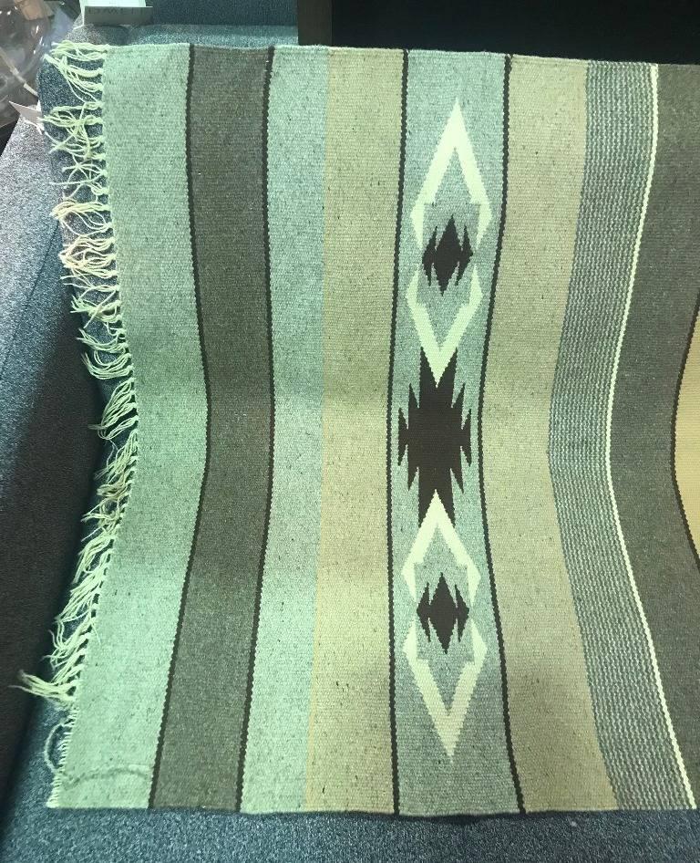 A nicely hand loomed Native American (likely Navajo but we are not experts in this area) rug. Wonderfully designed with vivid colors and geometrical patterns. Would make for a nice addition to any collection or a perfect accent piece.

Dimensions: