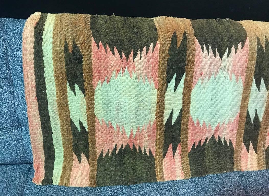 A Native American (perhaps Navajo, though we are not experts in this area)  mat or small rug. Handwoven and nicely graphically designed. From a collection of Native American artifacts. Would be a nice addition to any collection or a beautiful accent