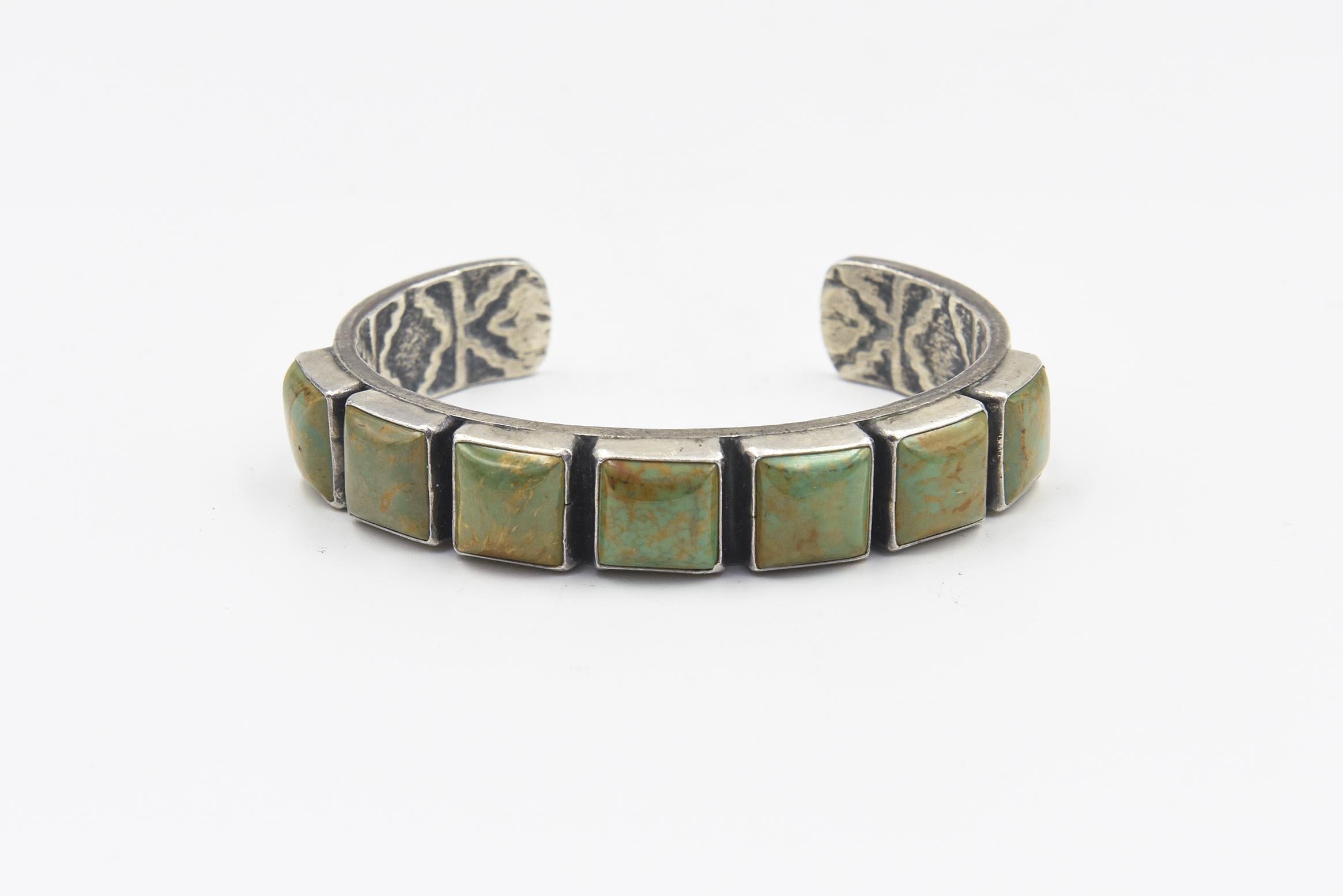 Vintage Native American Navajo Sterling Silver Green Turquoise Cuff Bracelet by Kirk Smith (1956-2012)

This beautiful Southwest sterling silver cuff bracelet is set with seven square turquoise cabochons in smooth bezel settings. The bracelet design