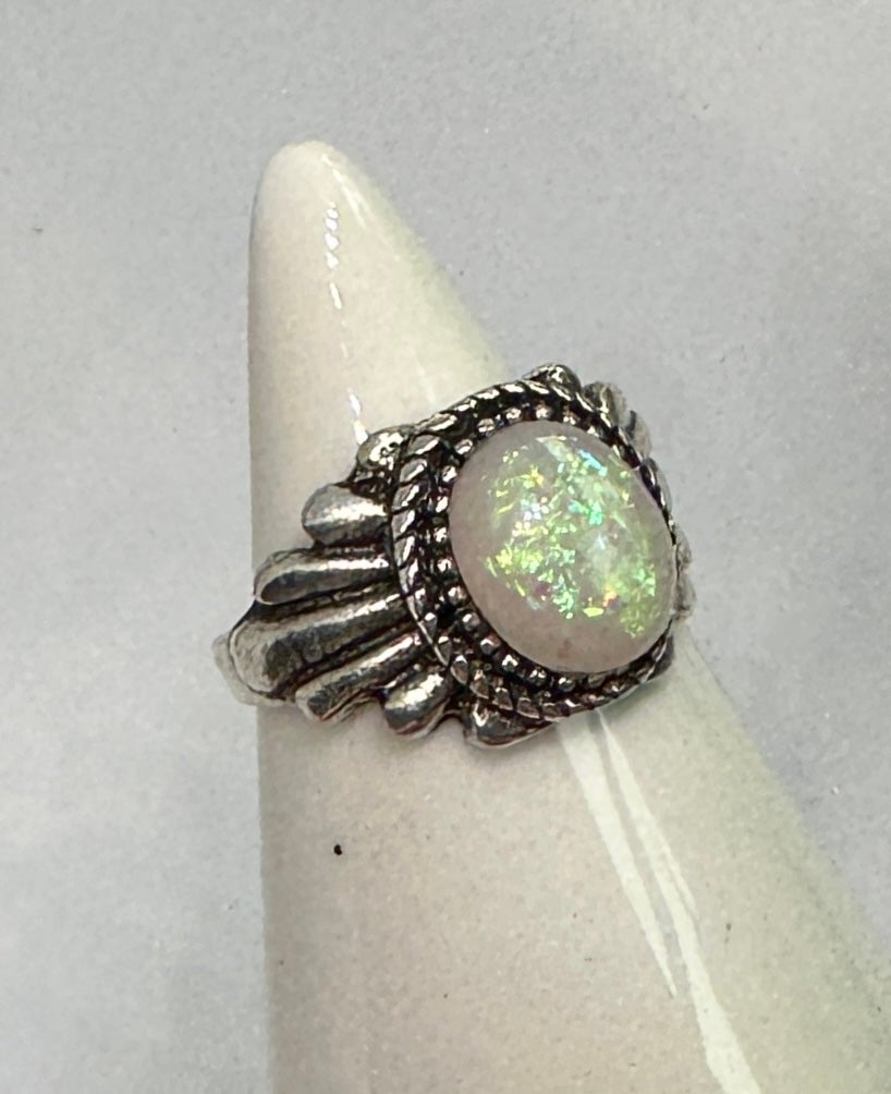 This is a stunning Native American Opal Sterling Silver Ring with a magnificent large 2.5 Carat Opal cabochon full of fabulous fire.  The opal has an abundance of greens, blues and yellow fire that is extraordinary.  The opal is 11mm by 8mm by 5mm