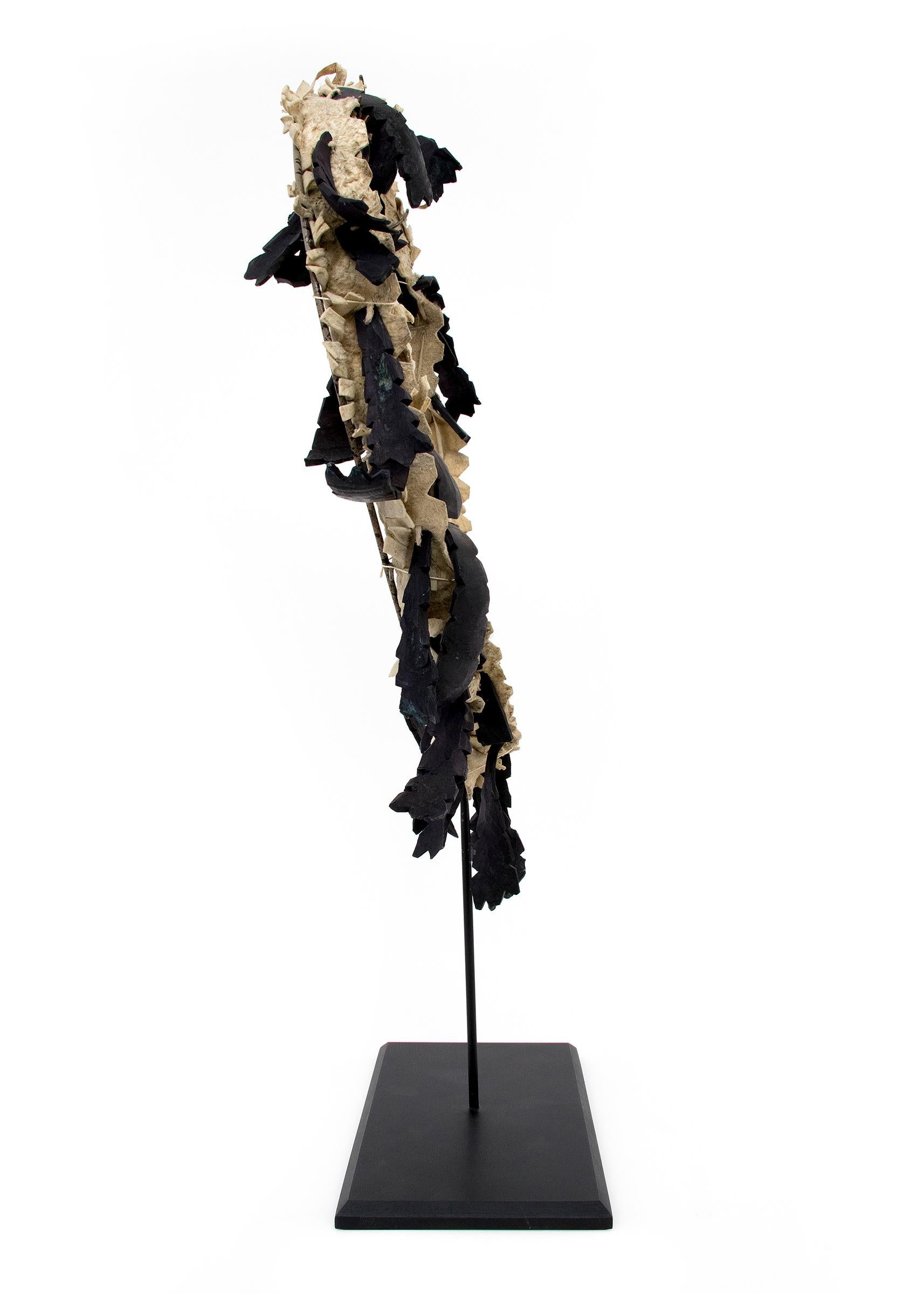 Plains Bandolier made with hide and deer dew claws from the first quarter of the 20th century. Presented with a custom display stand. Dimensions as displayed with stand measure 17 ½ x 7 x 3 ¾ inches.

Very good condition - please contact us for a