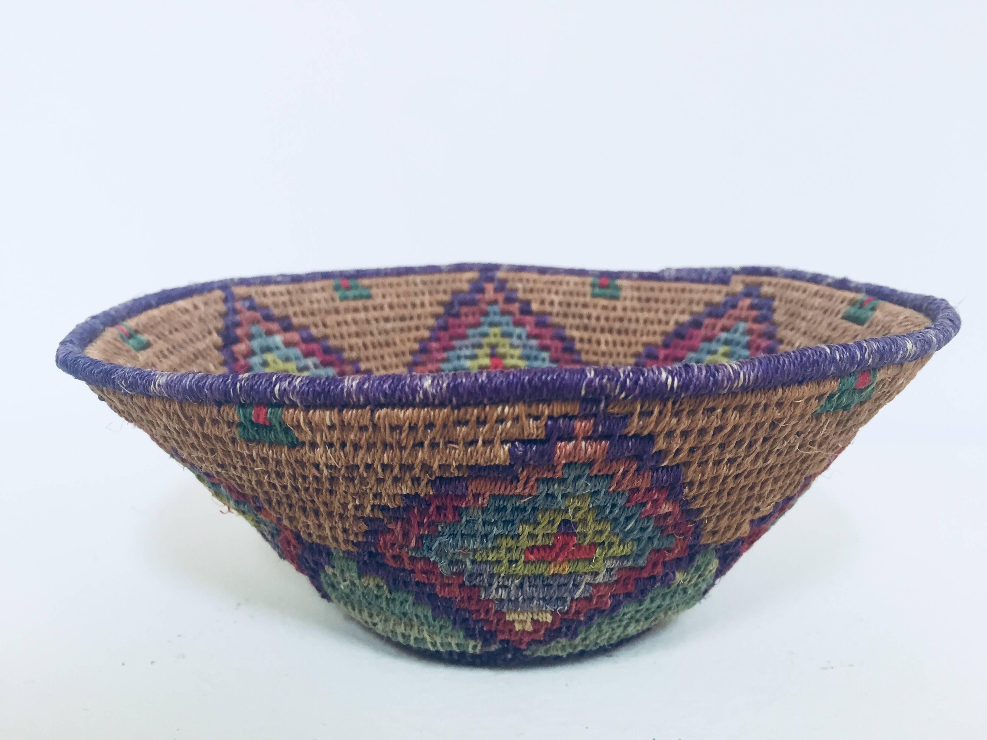Native American polychrome seagrass and silk woven basket. 
Beautiful round shape with geometric designs woven into the sides. 
Very fine craft work, great Folk Art collector piece.
Dimensions: 7