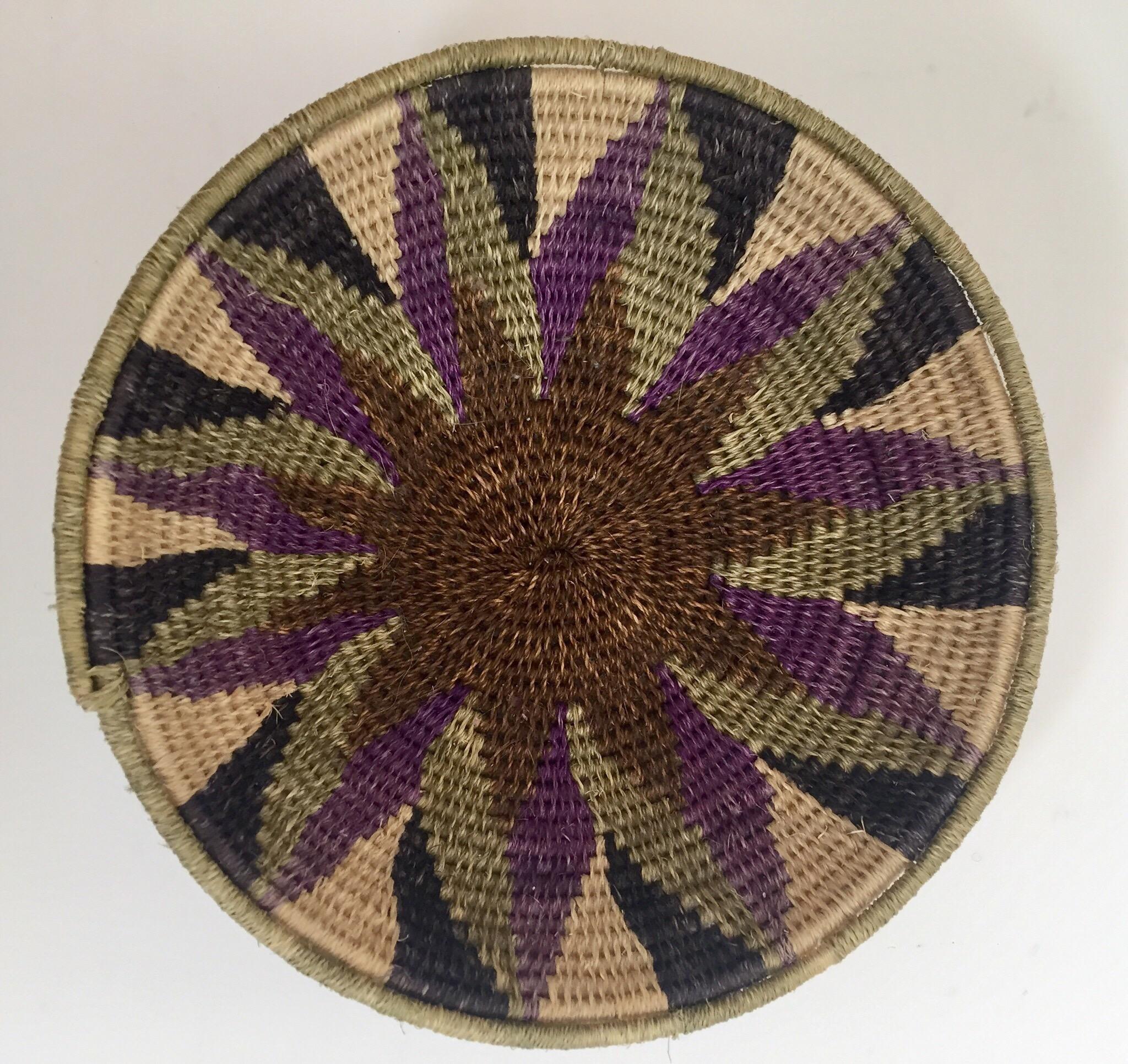 African polychrome seagrass and silk woven basket. 
Beautiful round shape with geometric designs woven into the sides. 
Very fine craft work, great Folk Art tribal collector piece.
Dimensions: 6.5