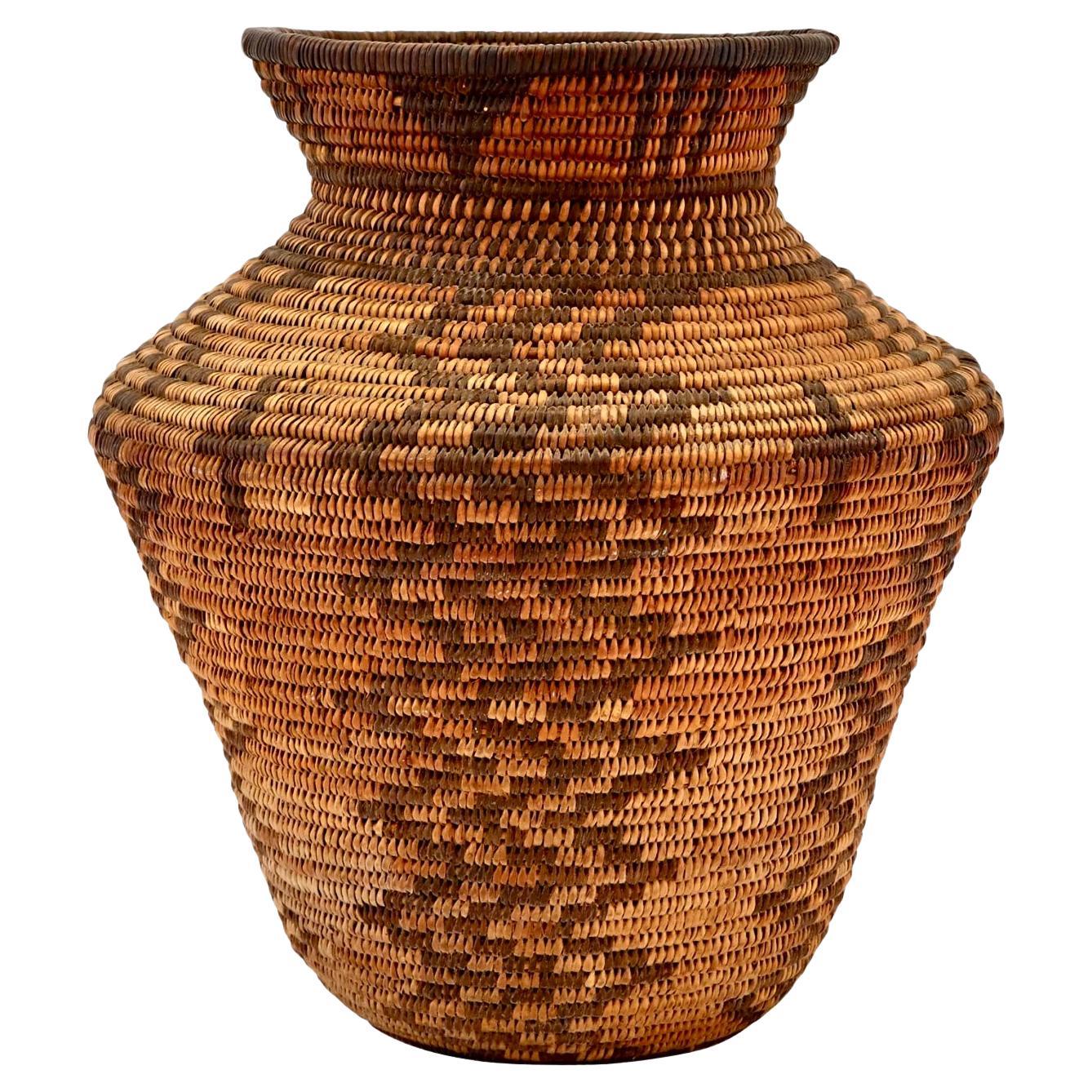 Early 20th century Native American Apache Olla in very good condition. This basket dates from the turn of the century and was made for self-use. A very tight example with a stunning design. Makes a great statement for any room as a piece of