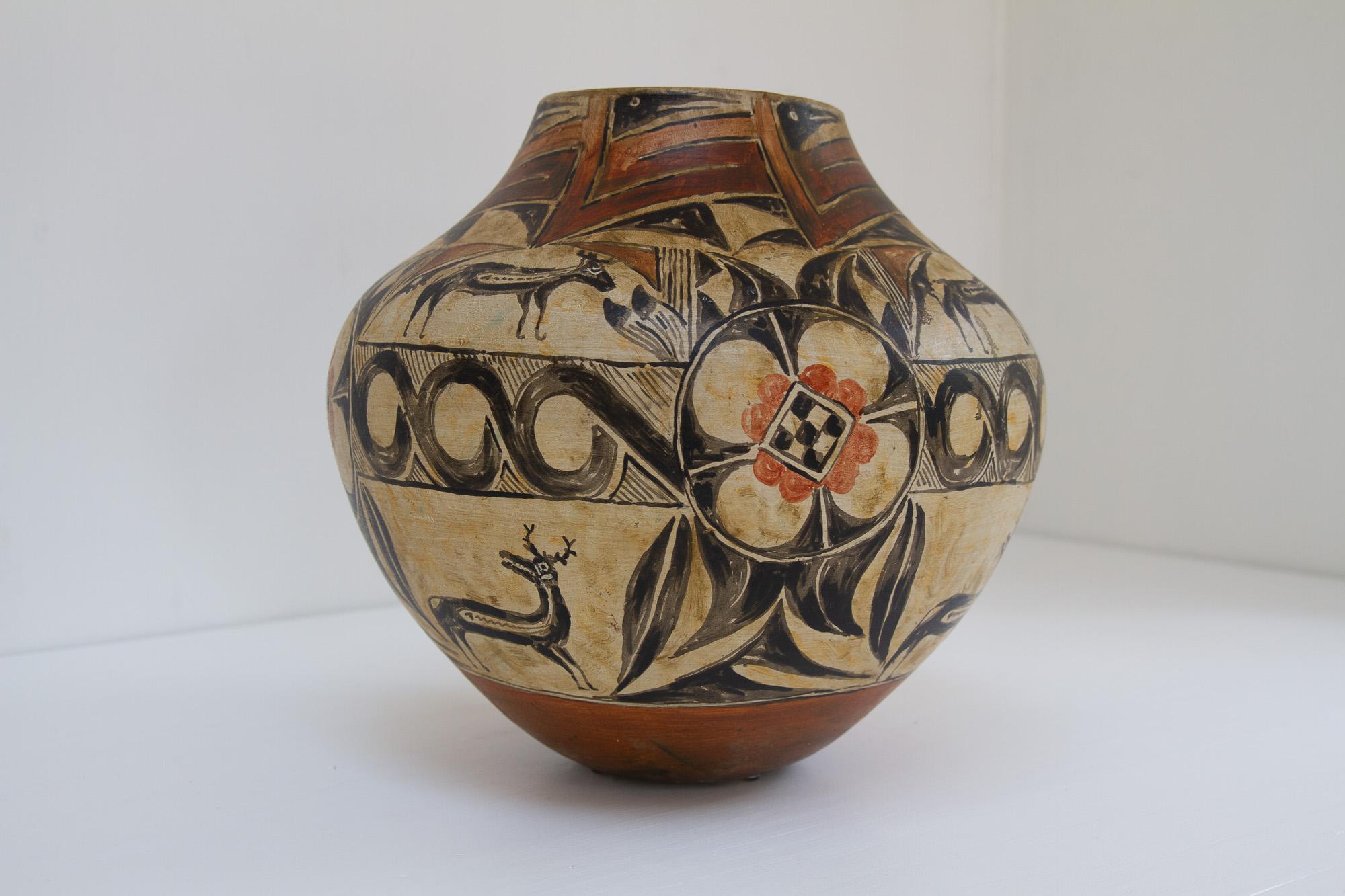 Native American Pueblo Olla Pottery, 1930s.
Large and heavy (7.8 kilograms) storage jar. Polychrome with deer, bird and floral motifs. This vase was bought by a Danish couple travelling to America in the early 20th century, and have been kept in a