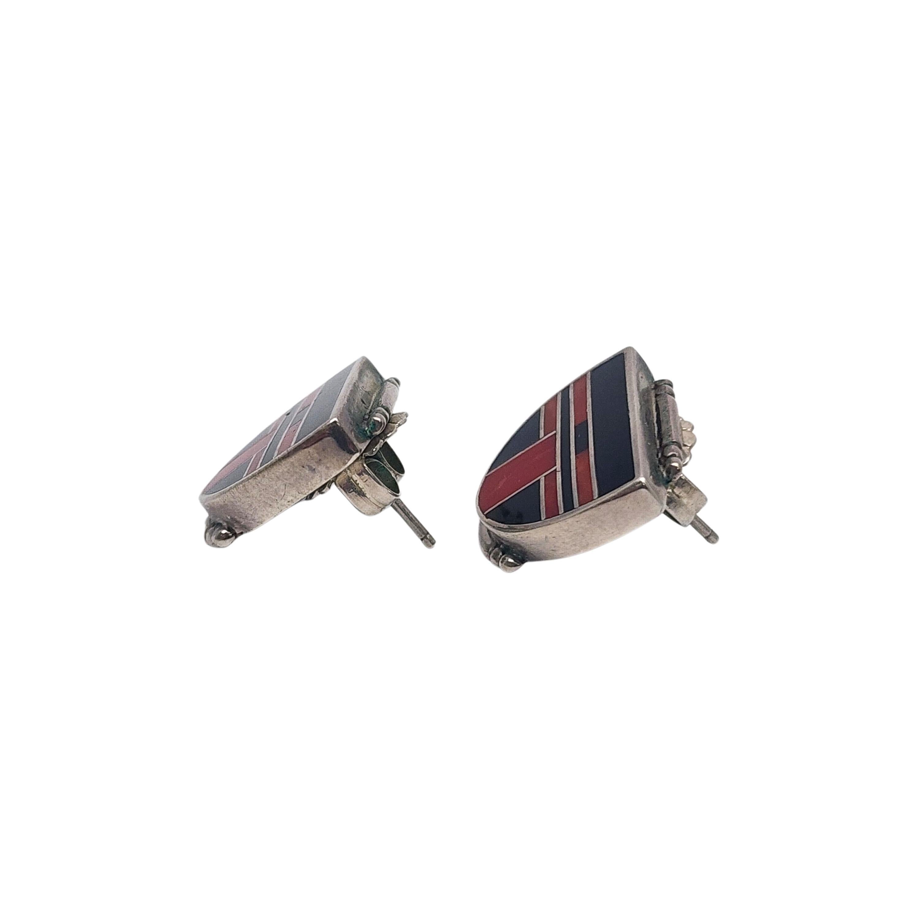 Sterling silver inlay earrings by Native American artisan Ray Tracey Knifewing.

These beautiful earrings feature an inlay design of what appears to be coral and onyx.

Weighs approx 9.4g, 6.0dwt.

Measures approx 3/4