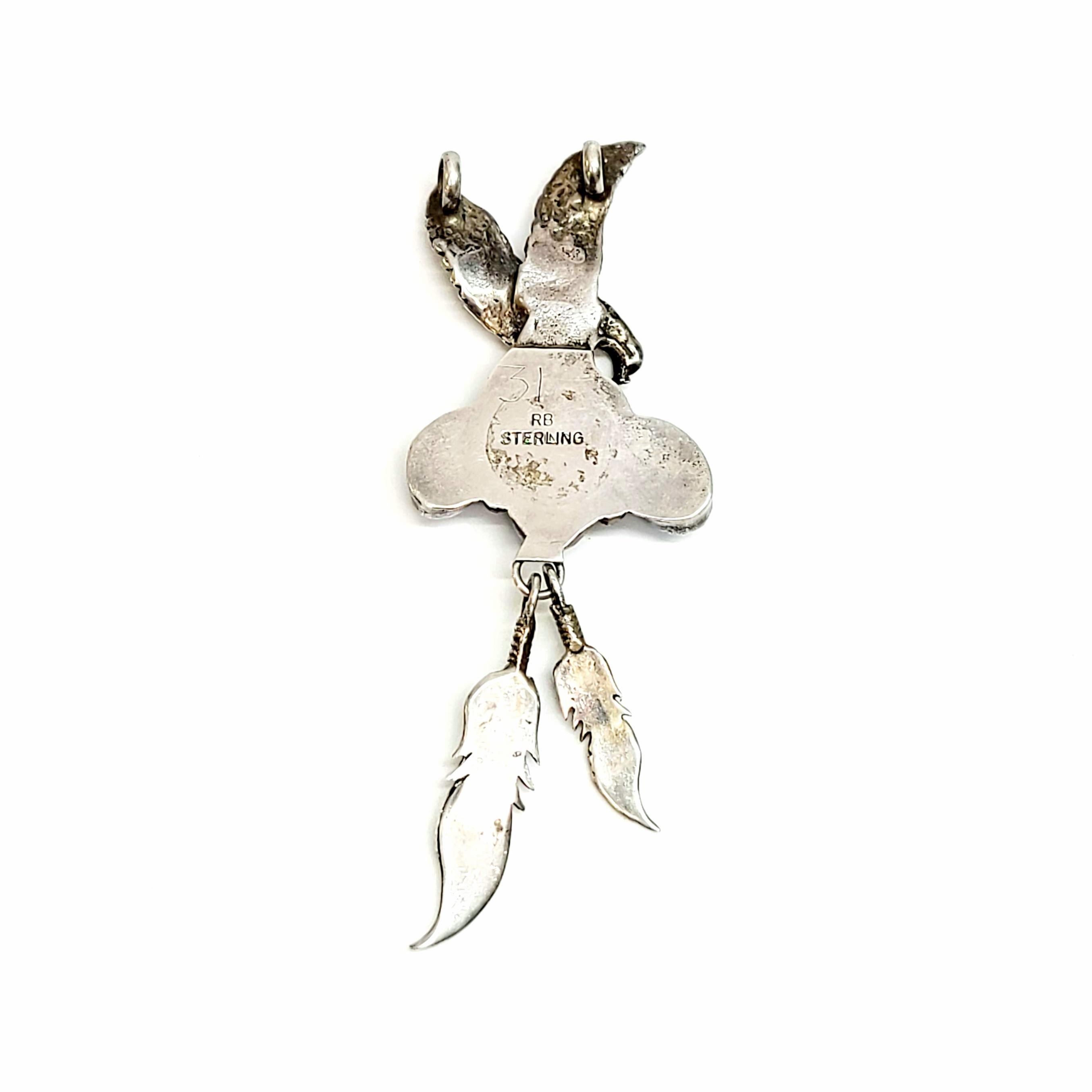 Sterling silver and turquoise eagle pendant by Native American Navajo artisan, Richard Begay.

Richard Begay was a seasoned Native American artisan whose work has been featured in the Smithsonian. He worked mostly with turquoise and coral and