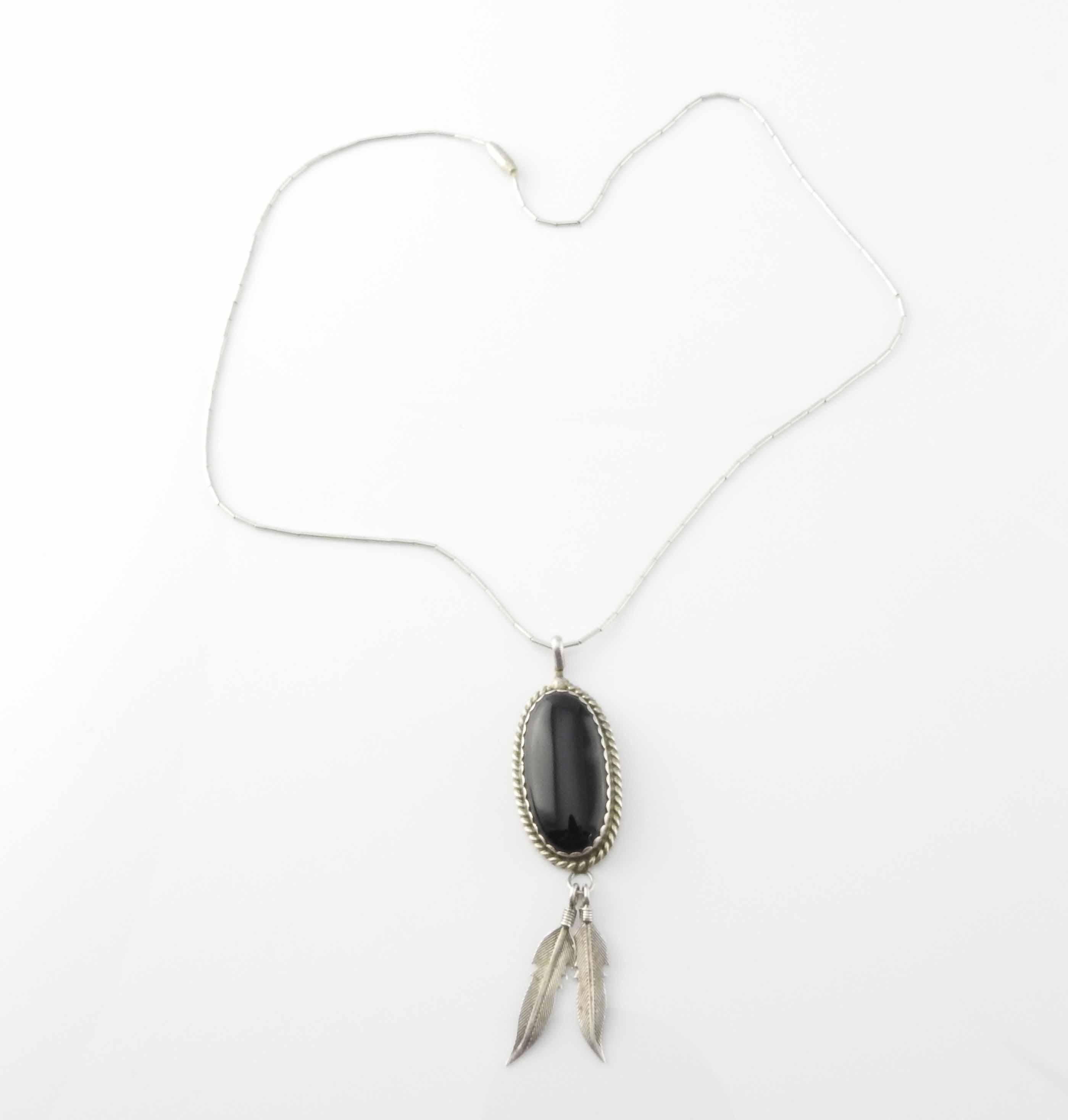 Native American 18 Inch Black Onyx Sterling Silver Feathers Necklace

Possibly by Keith James.

Marked: Sterling

Signed: K

Measurements: 18 inch strand

Center pendant: 9/16