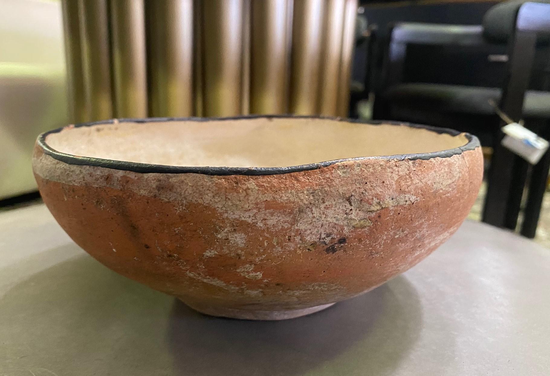 An interesting piece. Perhaps Southwestern Pueblo Pottery. It came from a collection of other Native American objects - pottery, rugs, blankets, etc...

The bowl is well made, wonderfully colored, and textured, and clearly has some age to it. We