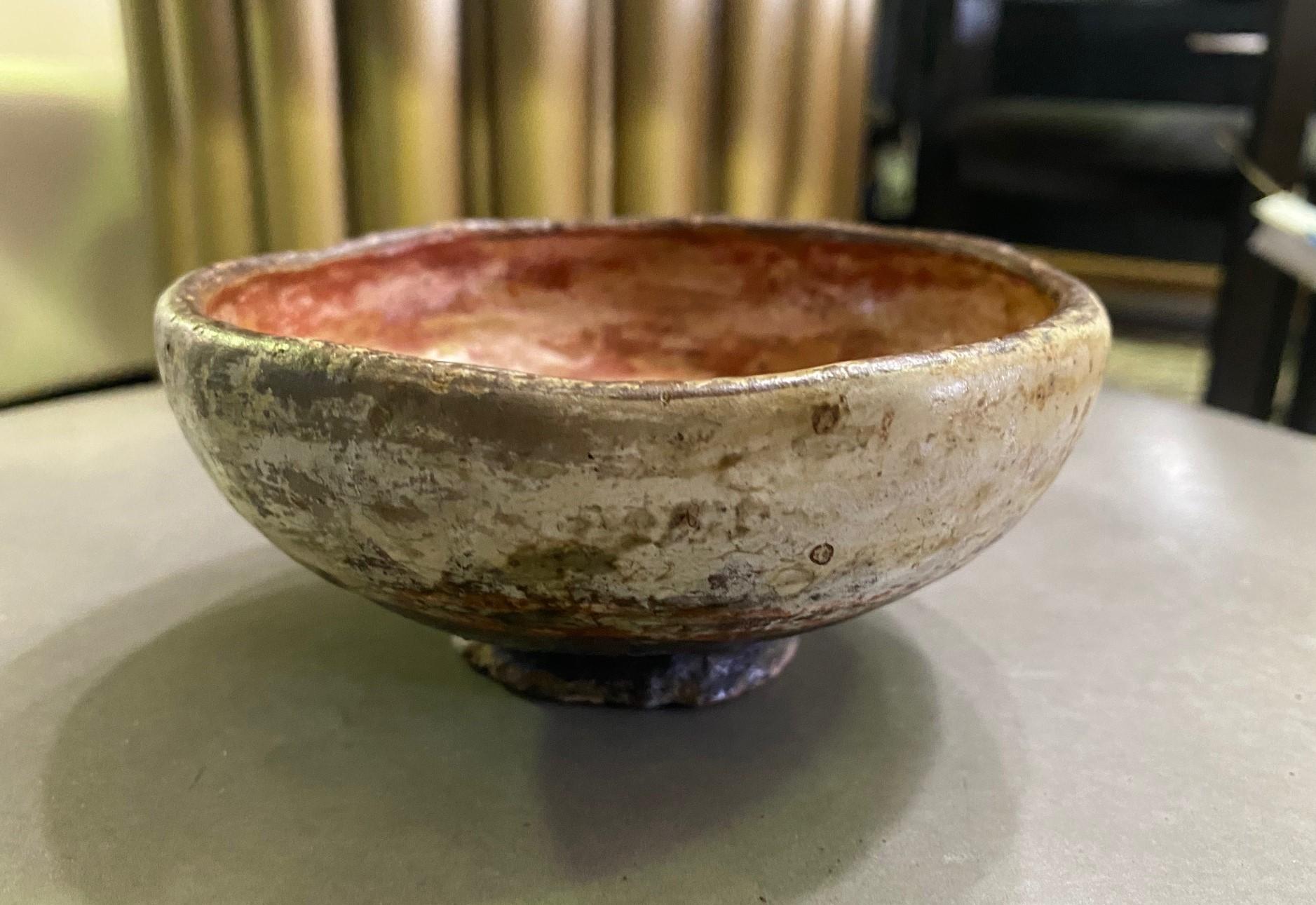 A wonderful gem. Perhaps Southwestern Pueblo pottery. Came from a collection of other Native American objects - pottery, blankets, rugs, etc.

The small bowl is clearly well made and wonderfully decorated, textured and colored with red pigment,