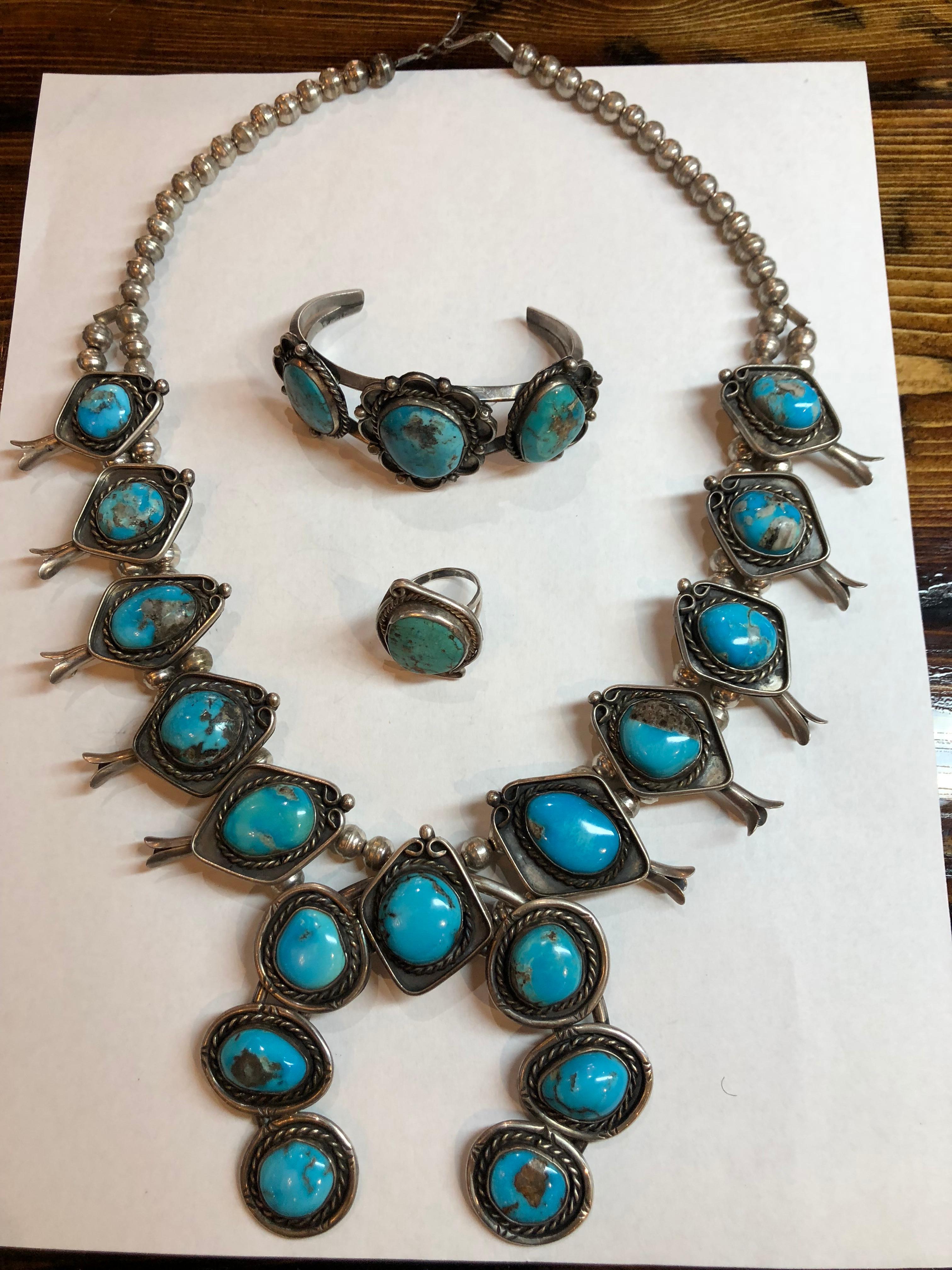 Native American Squash Blossom Silver and Turquoise Set
Sterling Silver and Turquoise
Necklace Bracelet and Ring (size 8.75)
Necklace weighs 178.8 Grams
Bracelet Weighs 41.9 Grams
Ring weighs 7.6 Grams