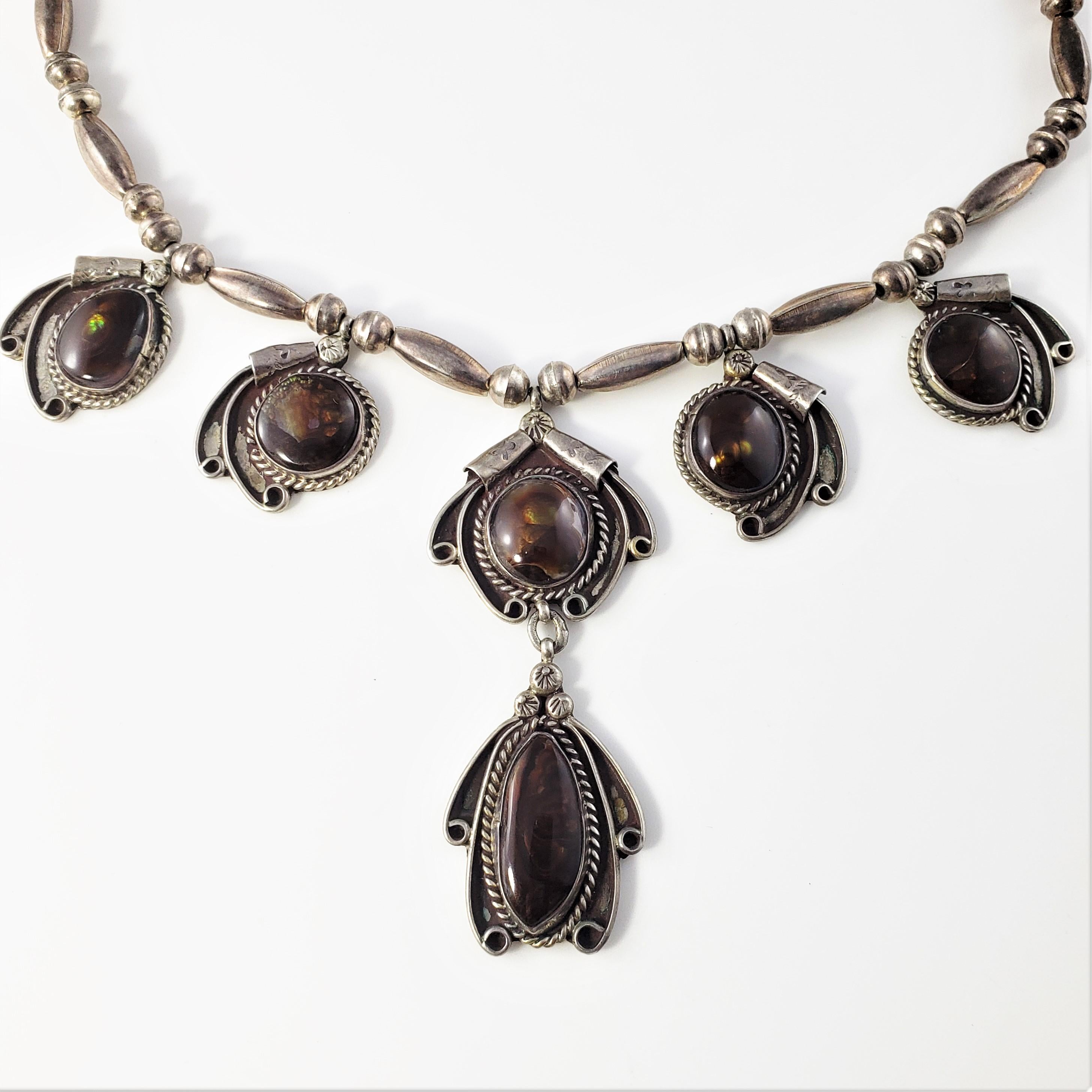 Vintage Native American Squash Blossom Style Sterling Silver Pietersite Necklace-

This lovely Native American necklace features three six pietersite stones (large: 25 mm x 12 mm, smaller stones: 15 mm x 14 mm each)

Size: 17 inches

Center drop: 3