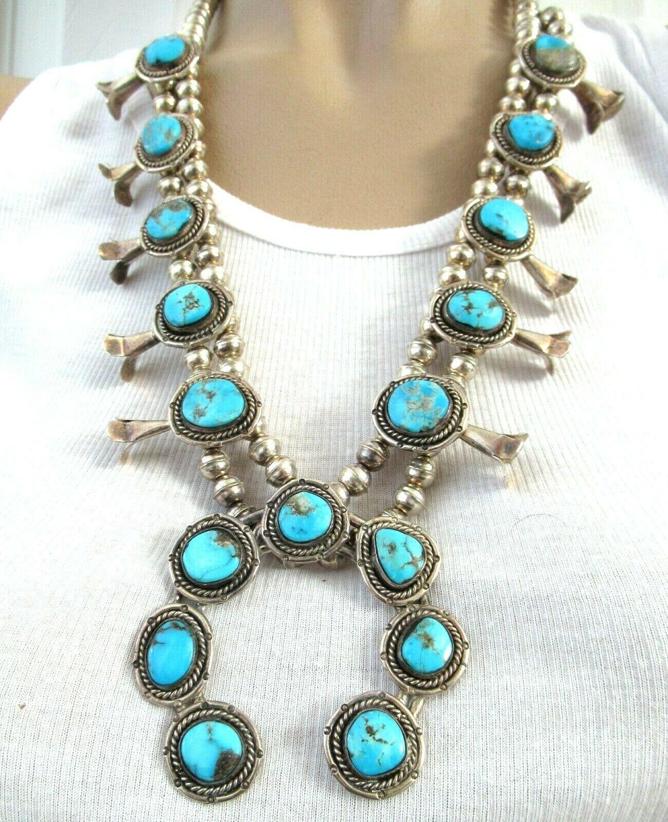 Highly desirable Large Native American original Old Pawn Navajo Squash Blossom Necklace. Featuring 10 Turquoise stations with a large center horseshoe Pendant set with 7 oval Turquoise. Measuring approx. 25.5