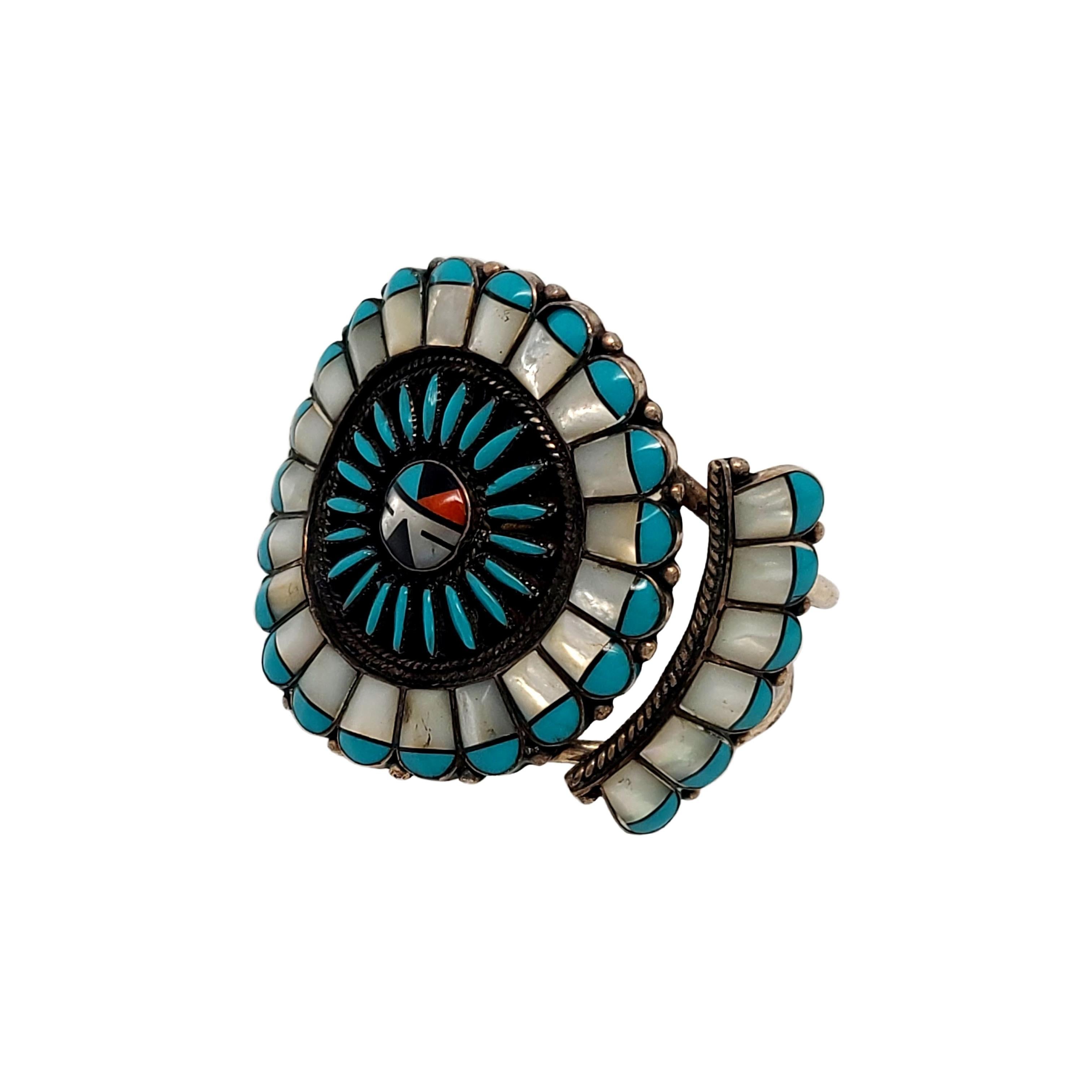 Sterling silver cuff bracelet by Native American artisan featuring needlepoint and cluster work.

Beautiful  small, round inlaid mosaic of onyx, mother of pearl, turquoise and red coral in a bezel setting surrounded by a needlepoint turquoise stones