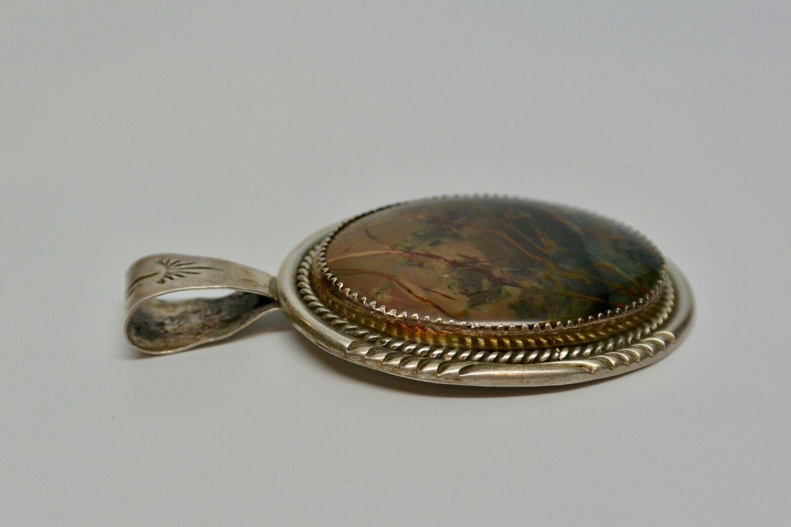 Sterling Silver Multi-Colored Stone Pendant Signed BB

Stone is rich with browns and greens. Signed 