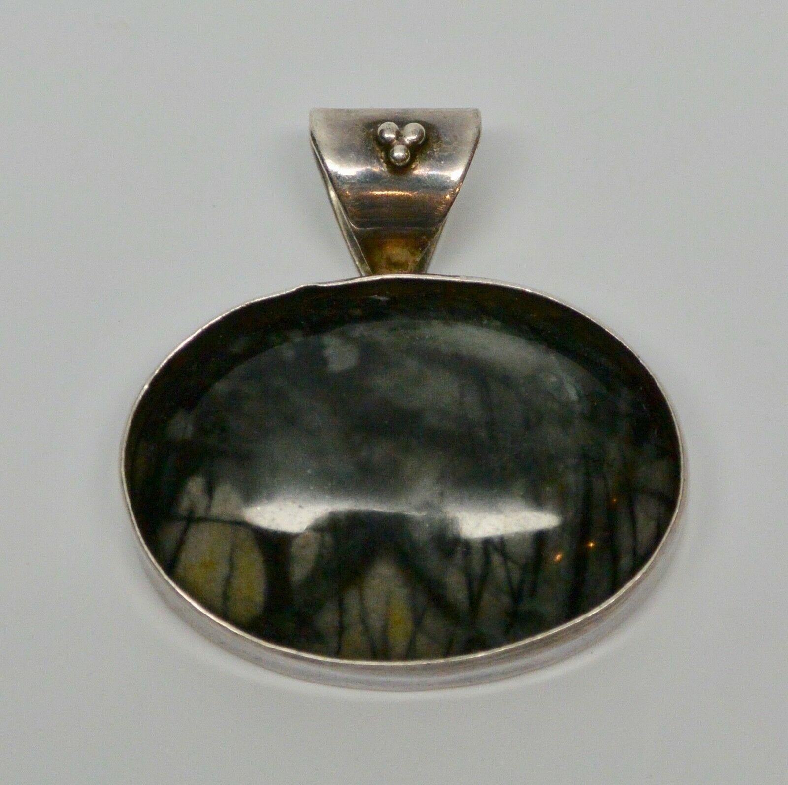 Native American Sterling Silver Oval Stone Pedant Signed R.J. Apacheto

Stone has rich black and gray coloring.

Marked: Sterling

Signed: R.J. Apacheto

Measurements:

1 5/16