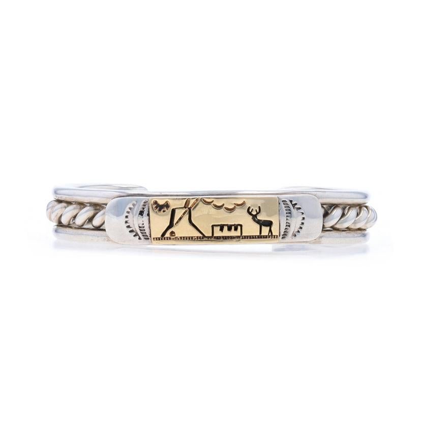 Native American
Artisan: TC Case & Co.
Tribal Affiliation: Navajo

Metal Content: Sterling Silver & 14k Yellow Gold

Style: Cuff
Fastening Type: N/A (slides over wrist)
Theme: Landscape
Features: Etched & Rope-Textured Detailing

Measurements
Inner