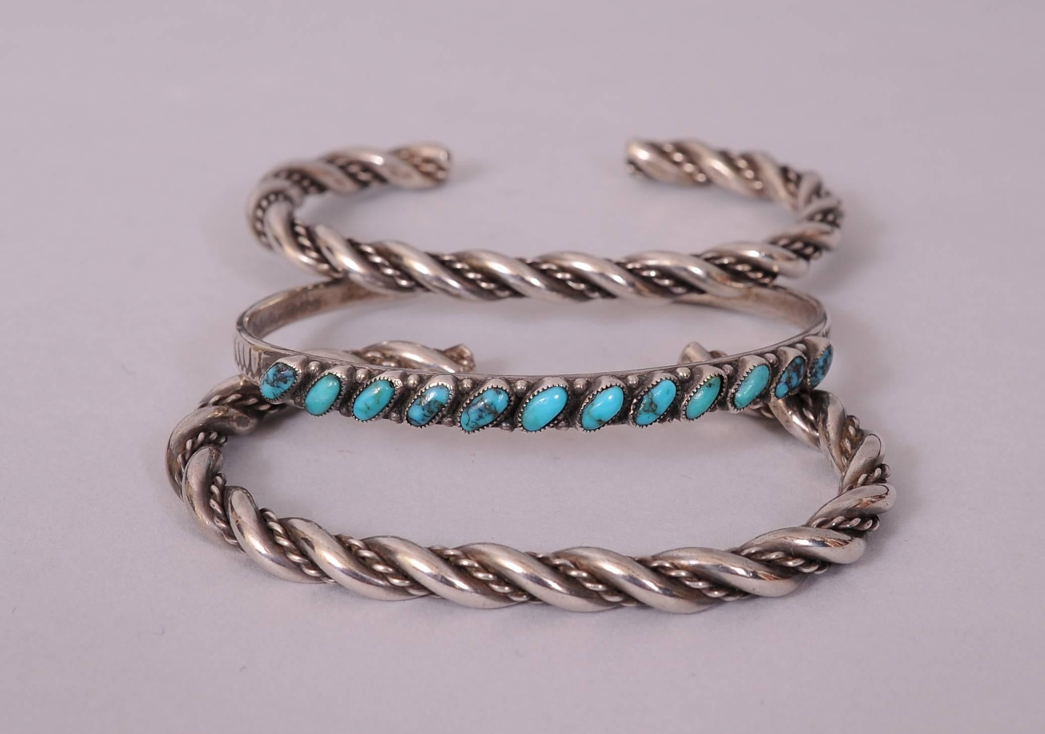 A pair of Native American silver twist bracelets are combined with a silver and turquoise bracelet for a lovely silver and turquoise stack of bracelets. All three are in excellent condition with a light patina.
Measurements:
Height 1/4