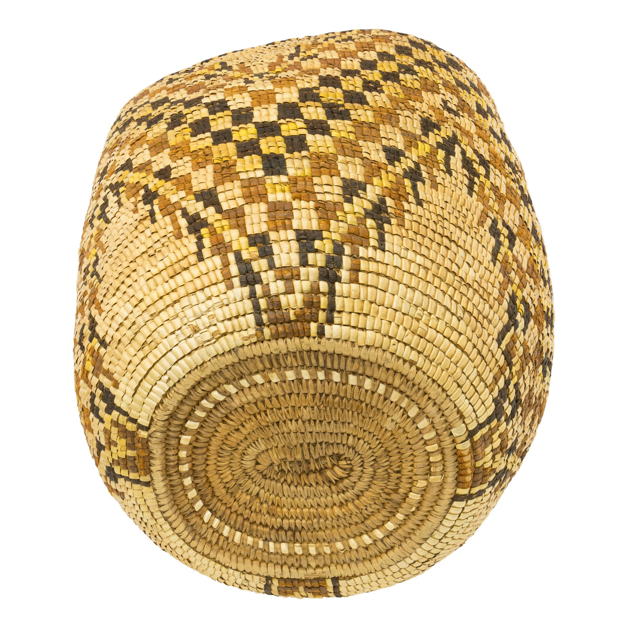 Yakama polychrome gathering basket. Fully imbricated, one flat side, having a geometric chevron design. Exceptional piece that would display nicely in any handmade indigenous basketry collection. Ex. Personal collection of Marcel Olney. Circa 1900.